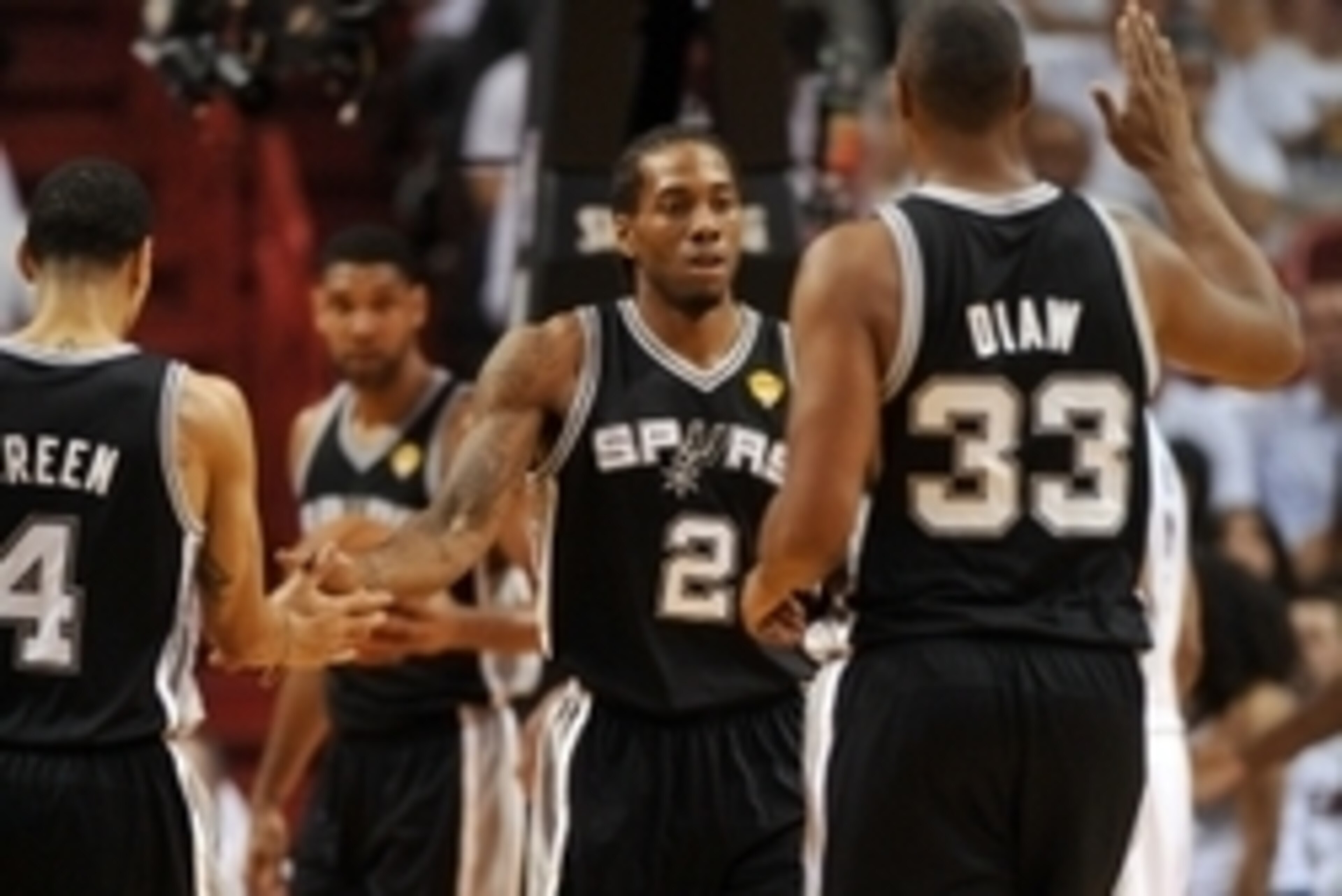 Jun 10, 2014; Miami, FL, USA; San Antonio Spurs forward Kawhi Leonard (2) high fives forward Boris Diaw (33) and guard Danny Green (4) during the first half of game three of the 2014 NBA Finals against the Miami Heat at American Airlines Arena. Mandatory 
