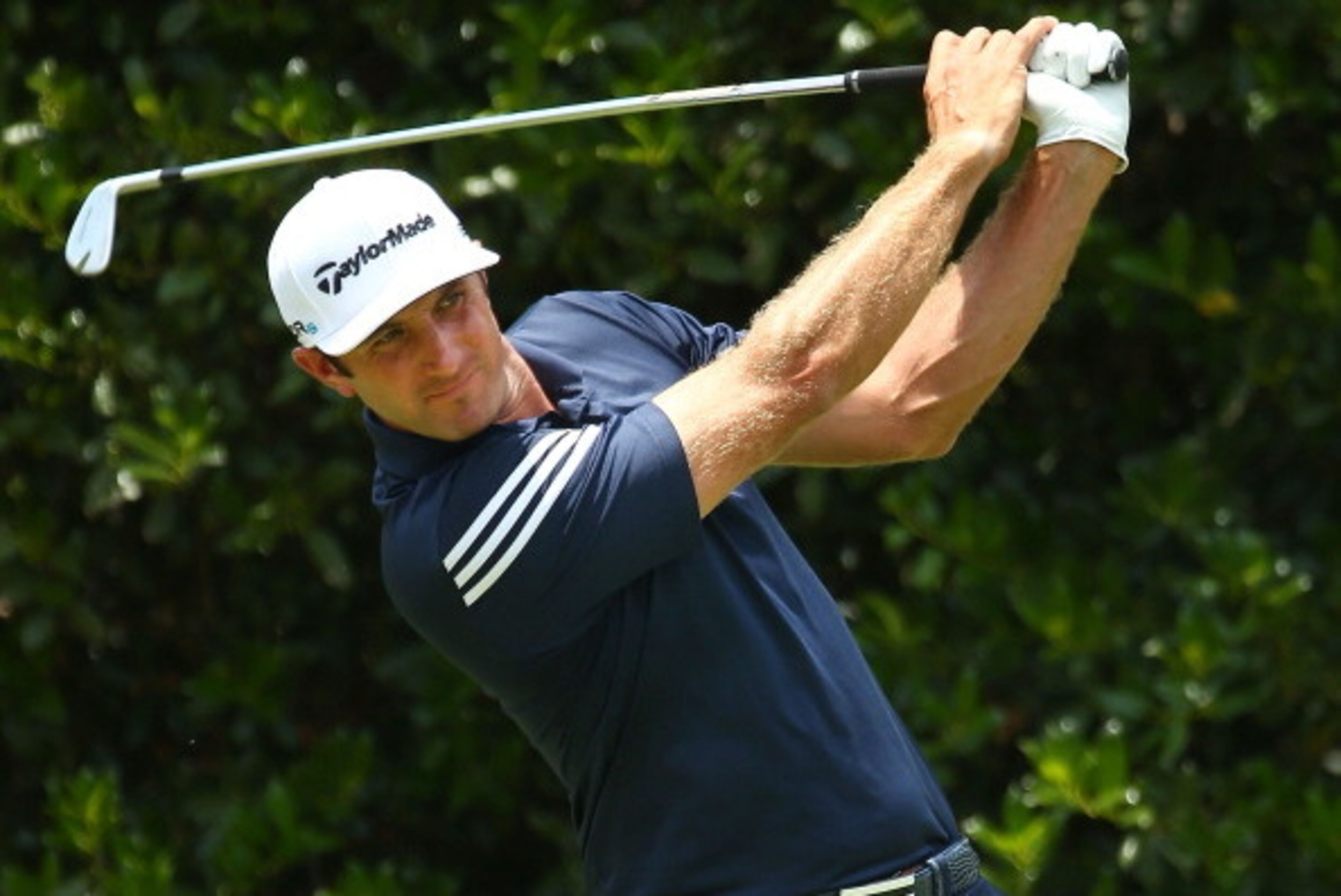 PINEHURST, NC - JUNE 09:  Dustin Johnson of the United States takes his tee shot during a practice round prior to the start of the 114th U.S. Open at Pinehurst Resort & Country Club, Course No. 2 on June 9, 2014 in Pinehurst, North Carolina.  (Photo by St