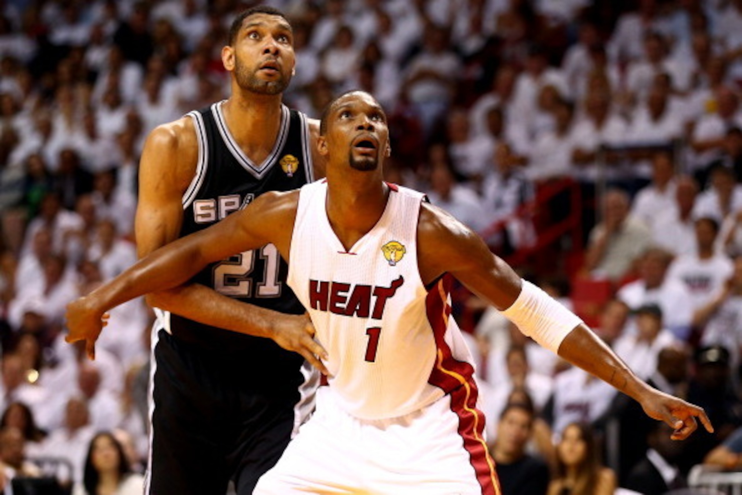 MIAMI, FL - JUNE 10: Chris Bosh #1 of the Miami Heat boxes out Tim Duncan #21 of the San Antonio Spurs during Game Three of the 2014 NBA Finals at American Airlines Arena on June 10, 2014 in Miami, Florida. NOTE TO USER: User expressly acknowledges and ag MIAMI, FL - JUNE 10: Chris Bosh #1 of the Miami Heat boxes out Tim Duncan #21 of the San Antonio Spurs during Game Three of the 2014 NBA Finals at American Airlines Arena on June 10, 2014 in Miami, Florida. NOTE TO USER: User expressly acknowledges and ag