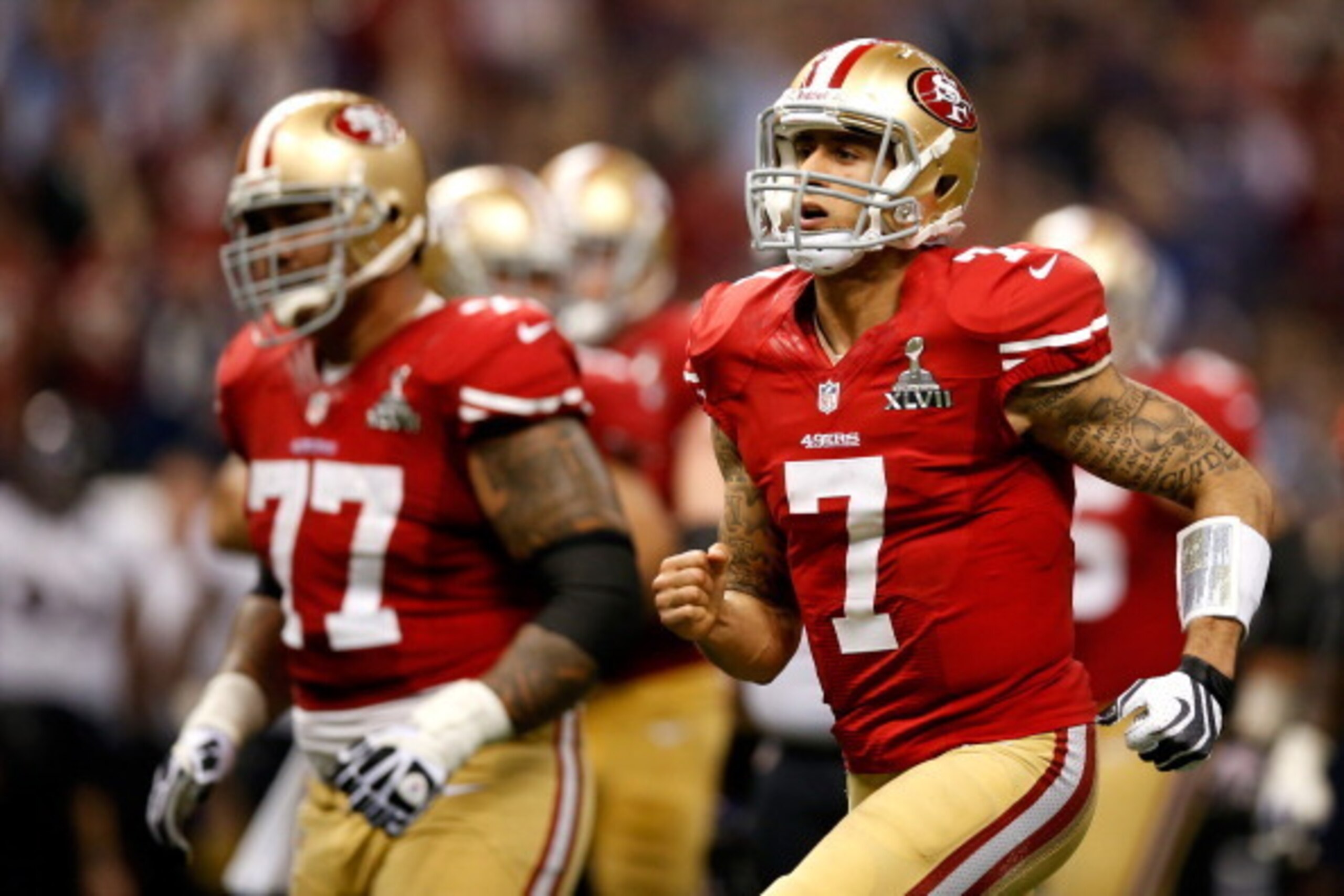 NEW ORLEANS, LA - FEBRUARY 03:  (L-R) Mike Iupati #77 and Colin Kaepernick #7 of the San Francisco 49ers run on the field against the Baltimore Ravens during Super Bowl XLVII at the Mercedes-Benz Superdome on February 3, 2013 in New Orleans, Louisiana.  (