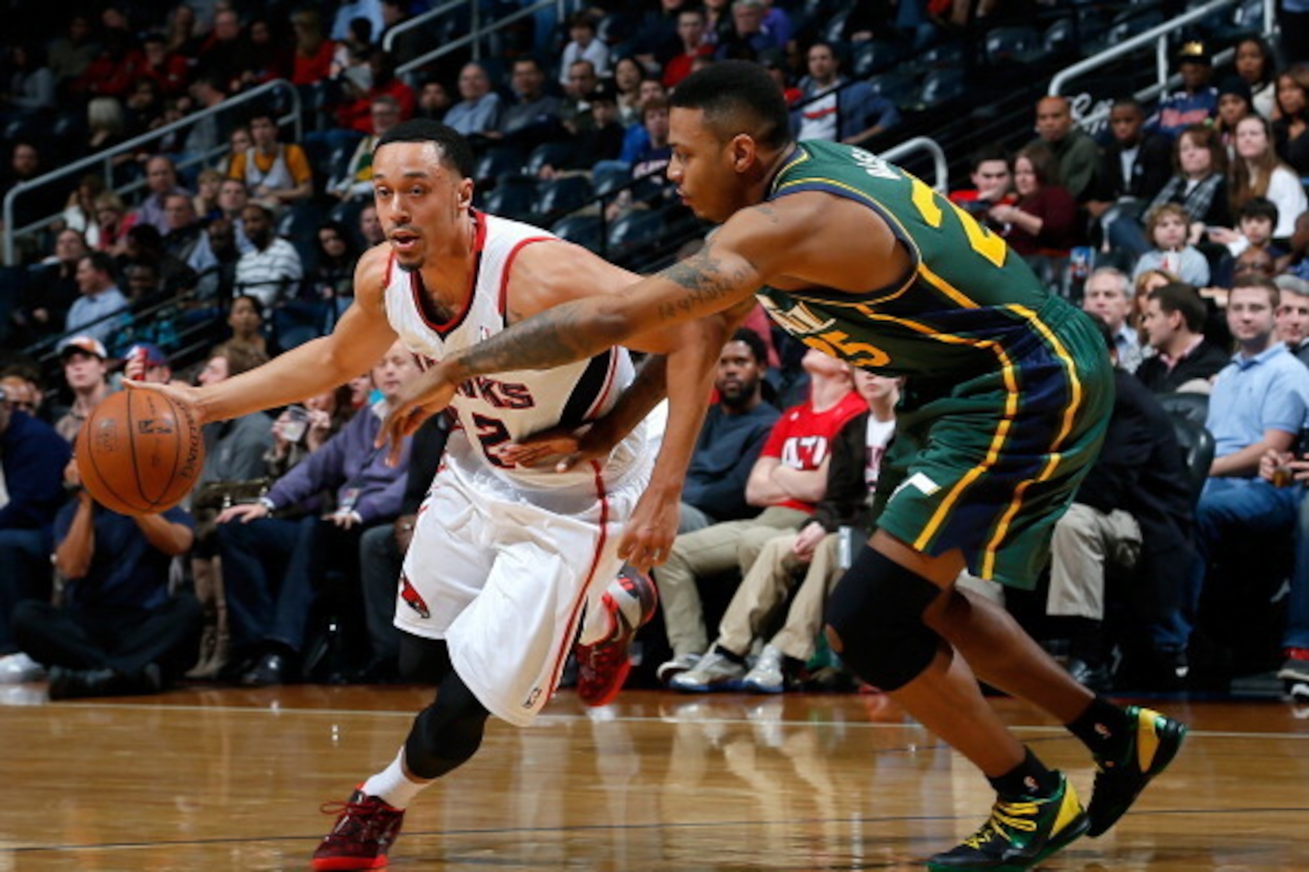 ATLANTA, GA - DECEMBER 20:  John Jenkins #12 of the Atlanta Hawks against Brandon Rush #25 of the Utah Jazz at Philips Arena on December 20, 2013 in Atlanta, Georgia.  NOTE TO USER: User expressly acknowledges and agrees that, by downloading and or using 