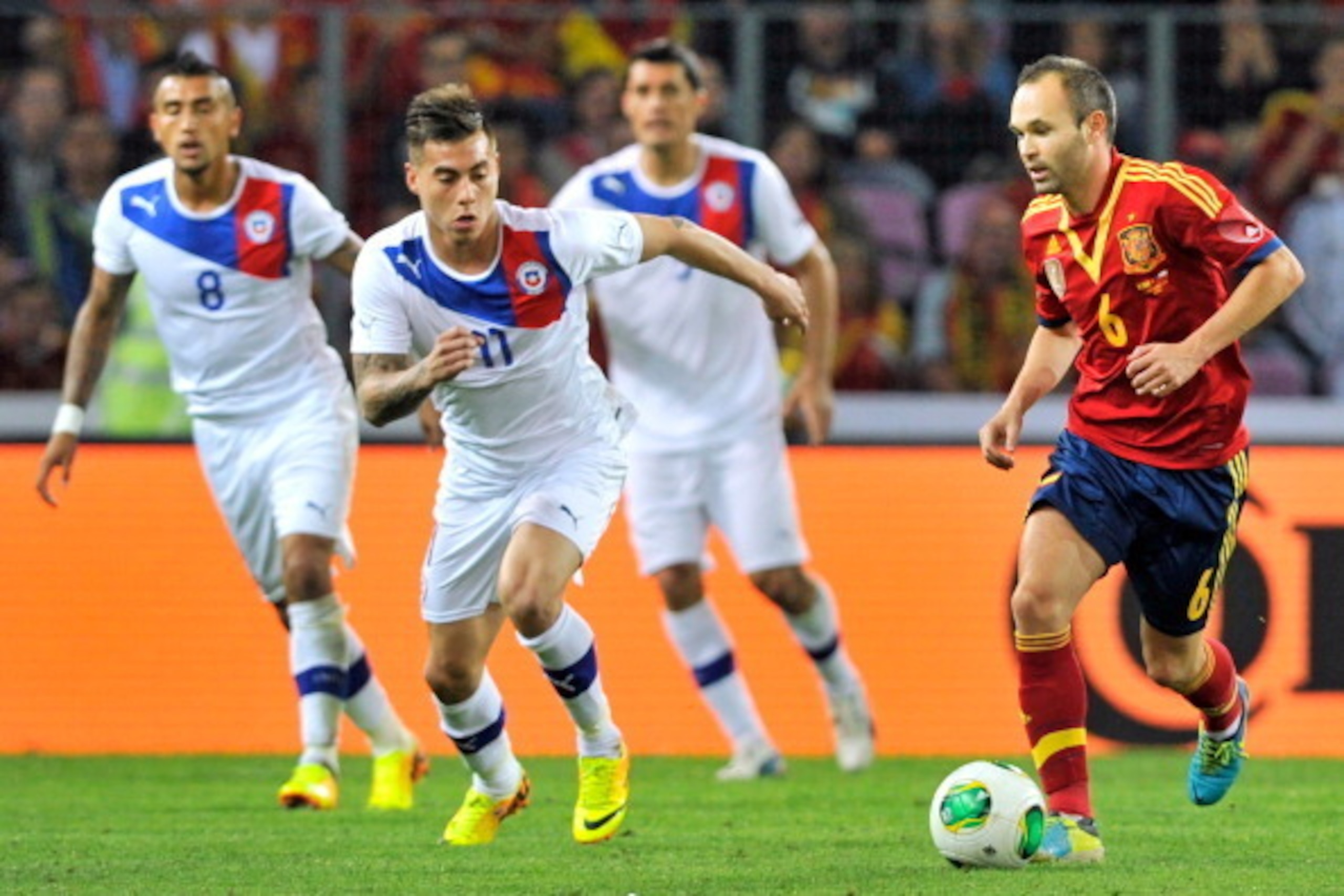 GENEVA, SWITZERLAND - SEPTEMBER 10:  Eduardo Vargas of Chile and Andres Iniesta of Spain compete for the ball during the Spain v Chile international friendly at Stade de Geneve on September 10, 2013 in Geneva, Switzerland.  (Photo by Harold Cunningham/Get