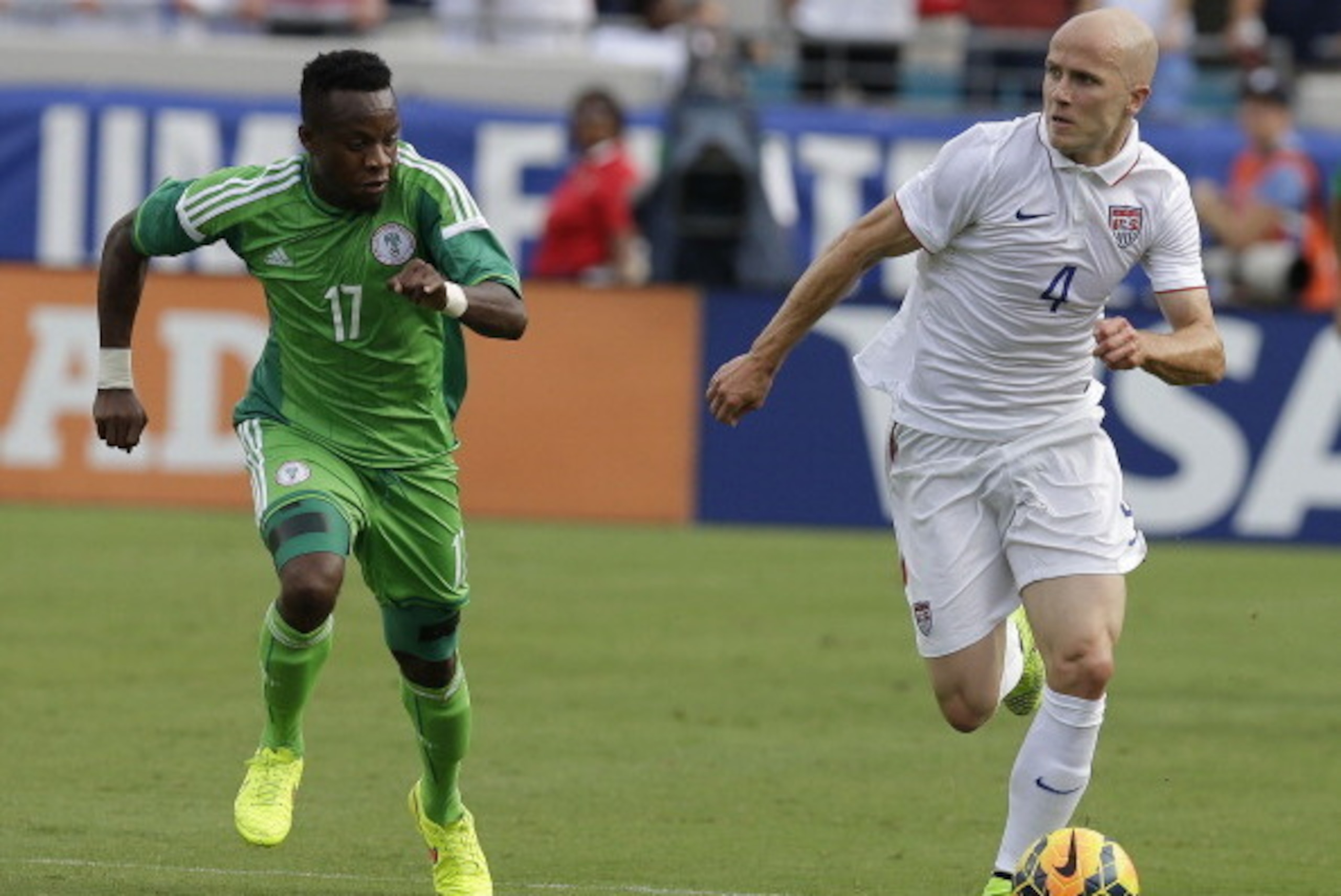 JACKSONVILLE, FL - JUNE 07:  Midfielder Michael Bradley #4 of the United States dribbles ahead of midfielder Ogenyi Onazi #17 of Nigeria during the international friendly match at EverBank Field on June 7, 2014 in Jacksonville, Florida.  (Photo by Mike Za