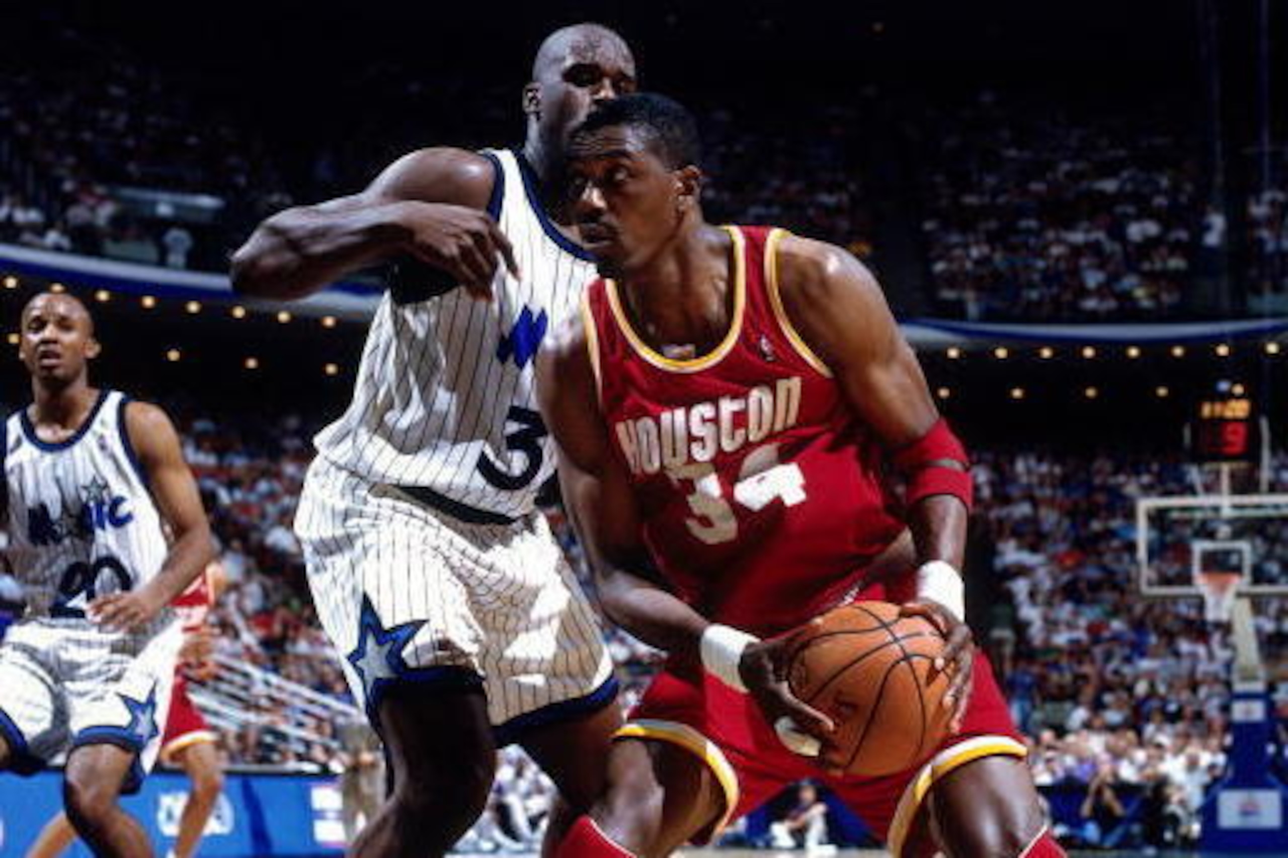 ORLANDO, FL - JUNE 9:  Hakeem Olajuwon #34 of the Houston Rockets stops his drive into the lane against Shaquille O'Neal #32 of the Orlando Magic during Game 2 of the1995 NBA Finals on June 9, 1995 at the Orlando Arena in Orlando, Florida.  Houston won 11
