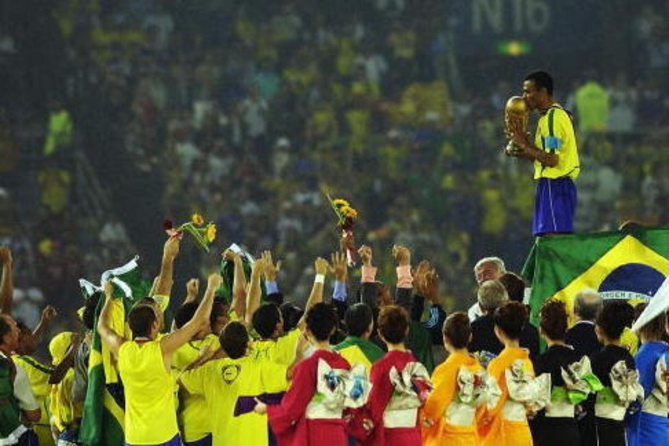 YOKOHAMA - JUNE 30:  Cafu on the podium celebrates with the World Cup trophy after the World Cup Final match against Germany played at the International Stadium Yokohama, Yokohama, Japan on June 30, 2002.  Brazil won the match 2-0. (Photo by Shaun Botteri