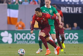 Jun 10, 2014; East Rutherford, NJ, USA; Portugal forward Cristiano Ronaldo (7) plays the ball while being defended by Ireland midfielder Jeff Hendrick (25) during the first half at MetLife Stadium. Mandatory Credit: Ed Mulholland-USA TODAY Sports