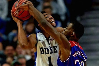 CHICAGO, IL - NOVEMBER 12: Jabari Parker #1 of the Duke Blue Devils tries to shoot against Andrew Wiggins #22 of the Kansas Jayhawks during the State Farm Champions Classic at the United Center on November 12, 2013 in Chicago, Illinois. Kansas defeated Du