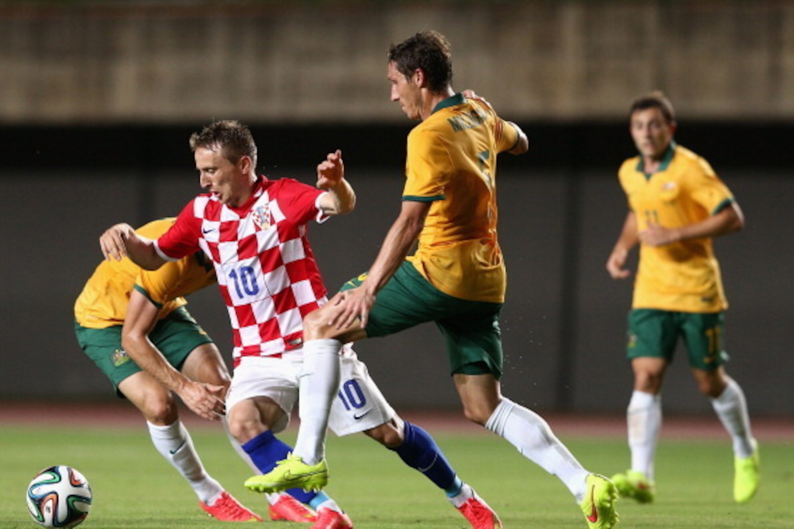 SALVADOR, BRAZIL - JUNE 06: Luka Modric of Croatia is tackled by Mark Milligan of the Socceroos during the International Friendly match between Croatia and the Australian Socceroos at Pituacu Stadium on June 6, 2014 in Salvador, Brazil.  (Photo by Cameron