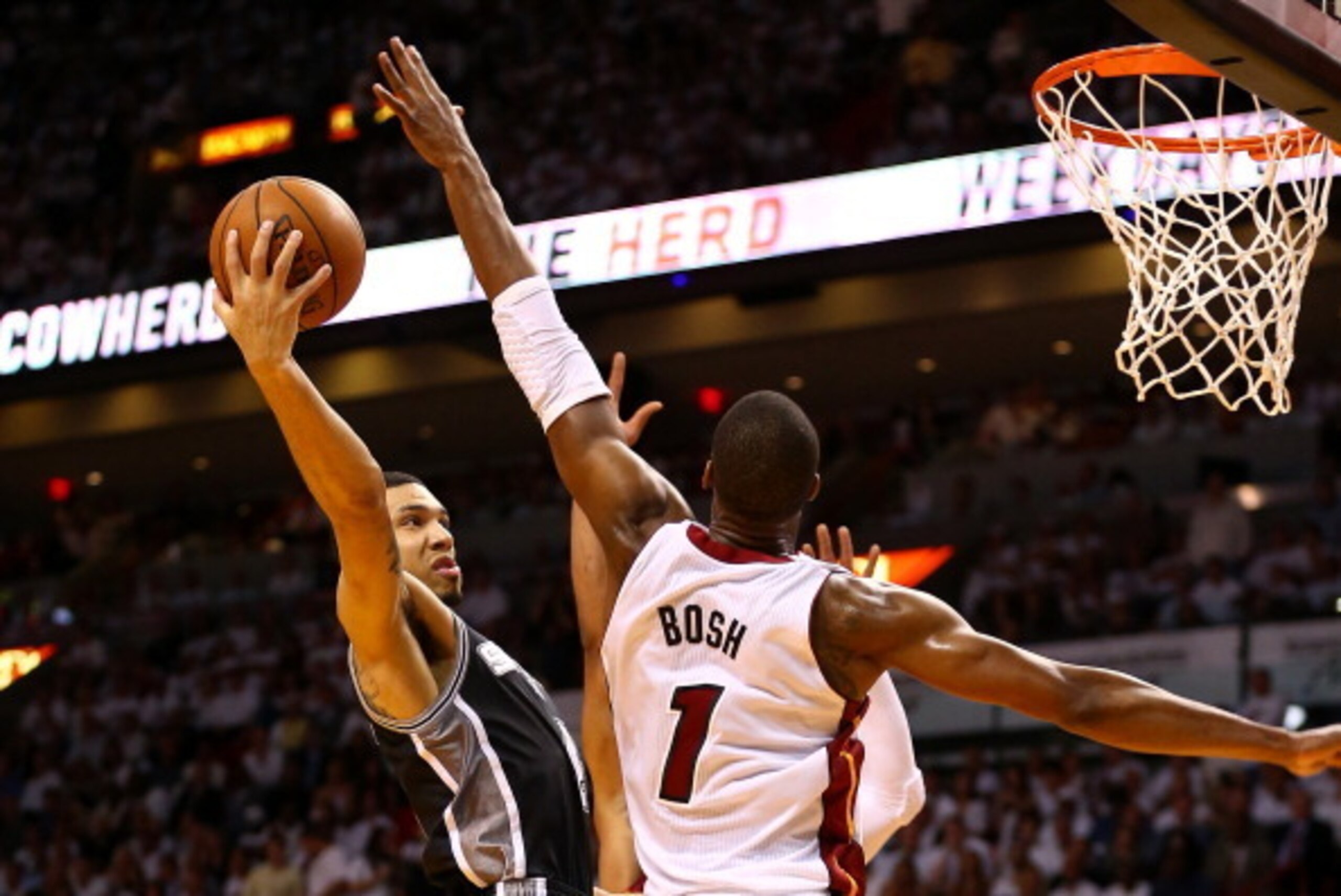 MIAMI, FL - JUNE 10:  Danny Green #4 of the San Antonio Spurs goes to the basket against Chris Bosh #1 of the Miami Heat during Game Three of the 2014 NBA Finals at American Airlines Arena on June 10, 2014 in Miami, Florida. NOTE TO USER: User expressly a