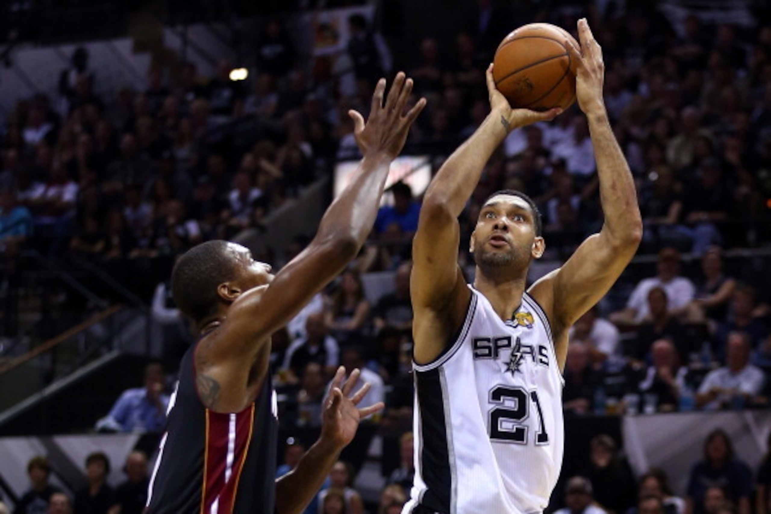SAN ANTONIO, TX - JUNE 08:  Tim Duncan #21 of the San Antonio Spurs takes a shot over Chris Bosh #1 of the Miami Heat during Game Two of the 2014 NBA Finals at the AT&T Center on June 8, 2014 in San Antonio, Texas. NOTE TO USER: User expressly acknowledge