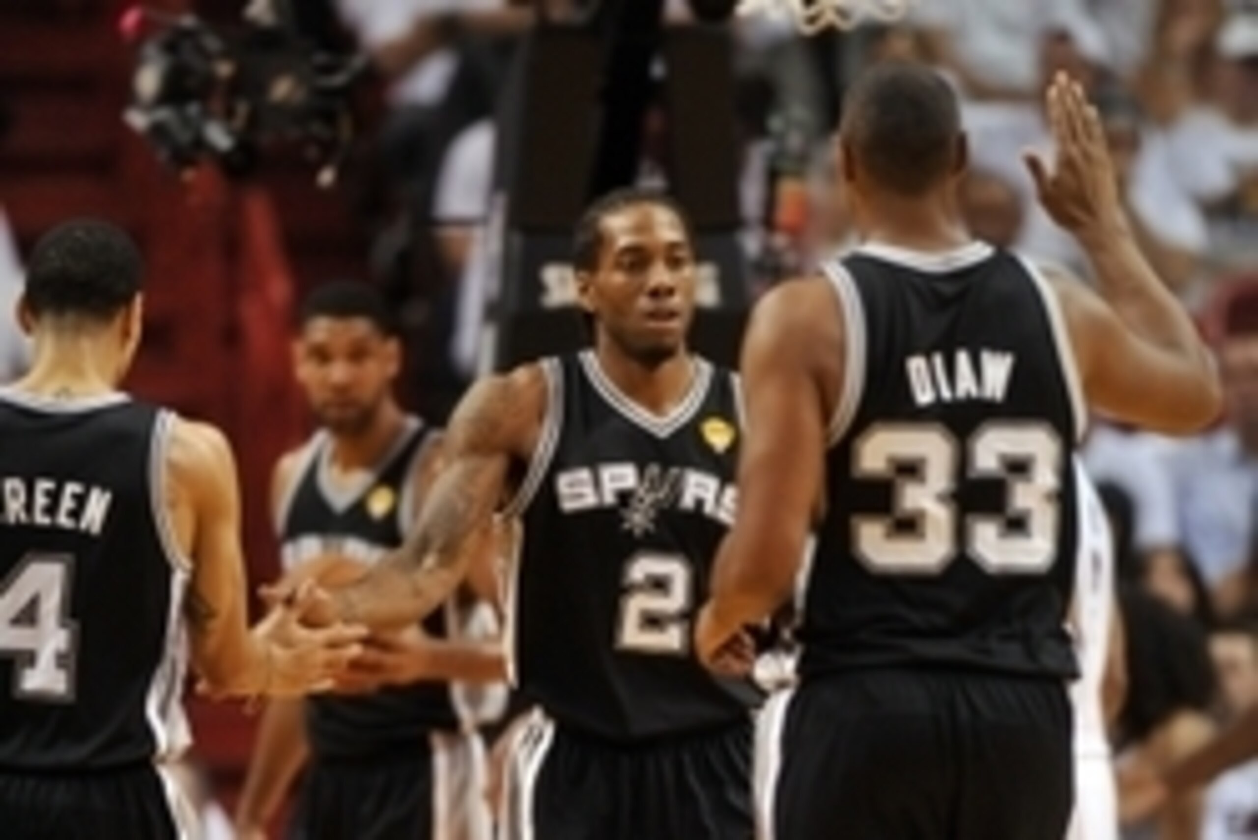 Jun 10, 2014; Miami, FL, USA; San Antonio Spurs forward Kawhi Leonard (2) high fives forward Boris Diaw (33) and guard Danny Green (4) during the first half of game three of the 2014 NBA Finals against the Miami Heat at American Airlines Arena. Mandatory Jun 10, 2014; Miami, FL, USA; San Antonio Spurs forward Kawhi Leonard (2) high fives forward Boris Diaw (33) and guard Danny Green (4) during the first half of game three of the 2014 NBA Finals against the Miami Heat at American Airlines Arena. Mandatory