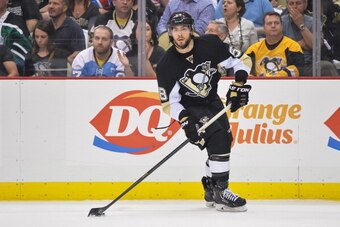 PITTSBURGH, PA - MAY 13:  Kris Letang #58 of the Pittsburgh Penguins skates with the puck against the New York Rangers in Game Seven of the Second Round of the 2014 NHL Stanley Cup Playoffs on May 13, 2014 at CONSOL Energy Center in Pittsburgh, Pennsylvan
