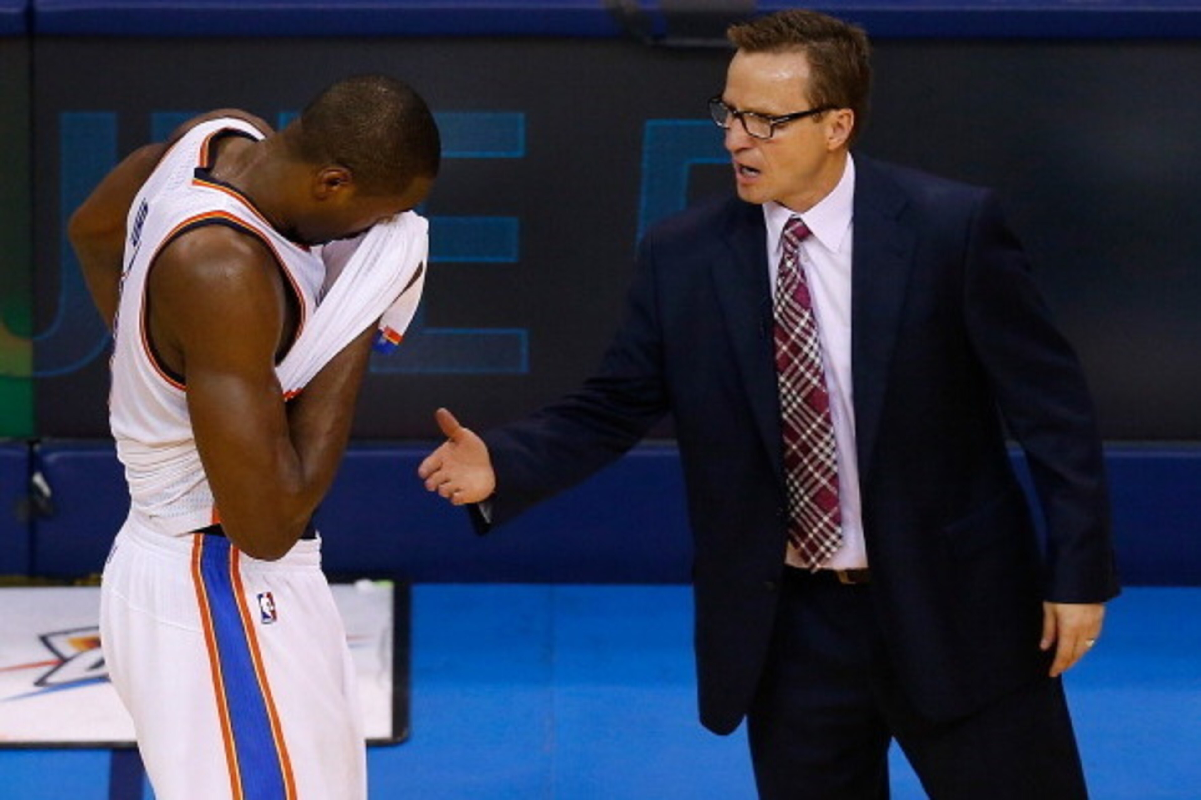 OKLAHOMA CITY, OK - MAY 31:  Serge Ibaka #9 of the Oklahoma City Thunder walks off the court to his coach Scott Brooks after the San Antonio Spurs defeated the Thunder 112-107 in overtime during Game Six of the Western Conference Finals of the 2014 NBA Pl