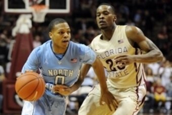 Feb 17, 2014; Tallahassee, FL, USA; Florida State Seminoles guard Aaron Thomas (25) chases North Carolina Tarheels guard Nate Britt (0) at the Donald L. Tucker Center. Mandatory Credit: Melina Vastola-USA TODAY Sports