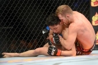 Jun 7, 2014; Albuquerque, NM, USA; Erik Perez (red) and Bryan Caraway (blue) fight during their bantamweight bout during UFC Fight Night 42 at Tingley Coliseum. Caraway won via second round submission. Mandatory Credit: Joe Camporeale-USA TODAY Sports