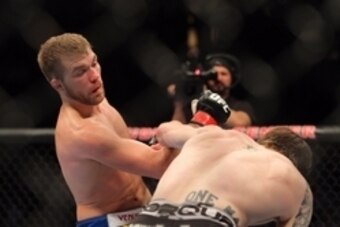Apr 27, 2013; Newark, NJ, USA; Bryan Caraway (blue shorts) competes against Johnny Bedford (black shorts) during UFC 159 at the Prudential Center. Mandatory Credit: Brad Penner-USA TODAY Sports