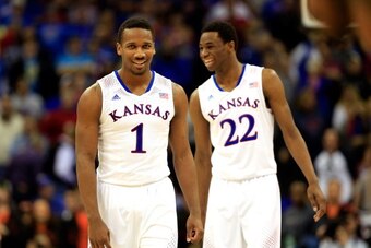 KANSAS CITY, MO - MARCH 13:  Wayne Selden, Jr. #1 of the Kansas Jayhawks celebrates with Andrew Wiggins #22 as the Jayahwks defeat the Oklahoma State Cowboys 77-70 to win the Big 12 Basketball Tournament quarterfinal game at Sprint Center on March 13, 201