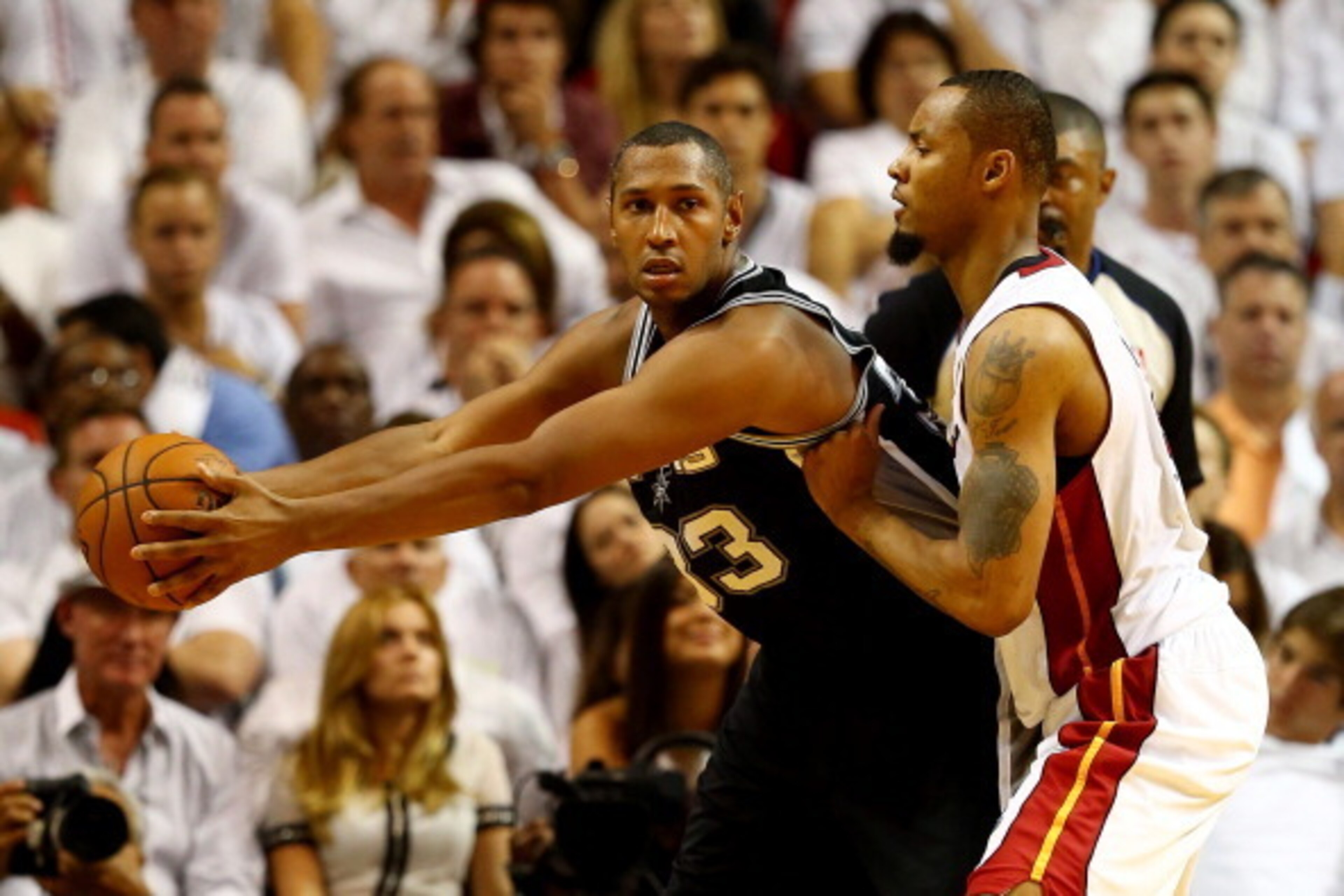 MIAMI, FL - JUNE 10: Boris Diaw #33 of the San Antonio Spurs controls the ball as Rashard Lewis #9 of the Miami Heat defends during Game Three of the 2014 NBA Finals at American Airlines Arena on June 10, 2014 in Miami, Florida. NOTE TO USER: User express