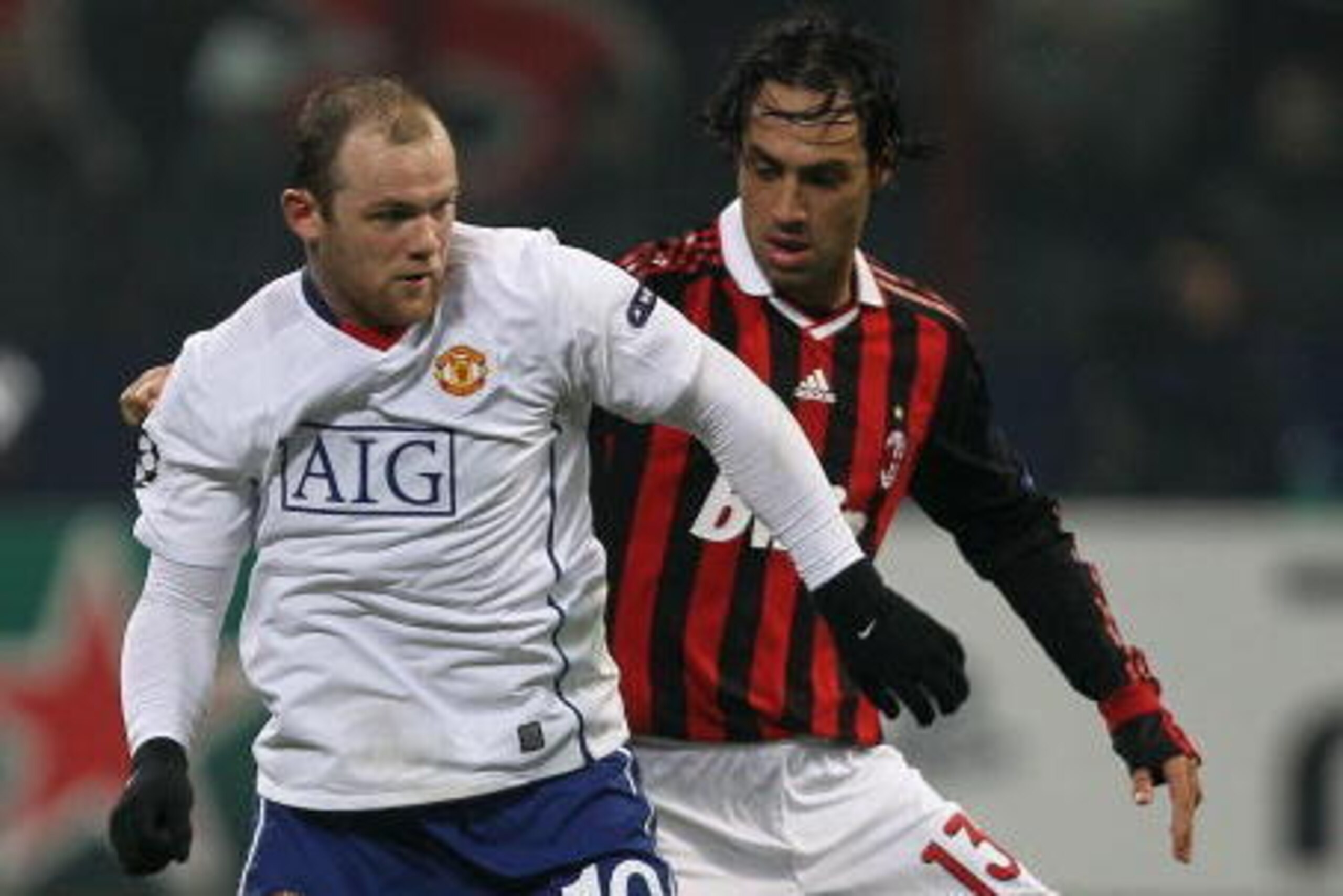 MILAN, ITALY - FEBRUARY 16: Wayne Rooney (L) of Manchester United contests with Alessandro Nesta of AC Milan during the UEFA Champions League round of 16 first leg match between AC Milan and Manchester United at Stadio Giuseppe Meazza on February 16, 201 MILAN, ITALY - FEBRUARY 16: Wayne Rooney (L) of Manchester United contests with Alessandro Nesta of AC Milan during the UEFA Champions League round of 16 first leg match between AC Milan and Manchester United at Stadio Giuseppe Meazza on February 16, 201