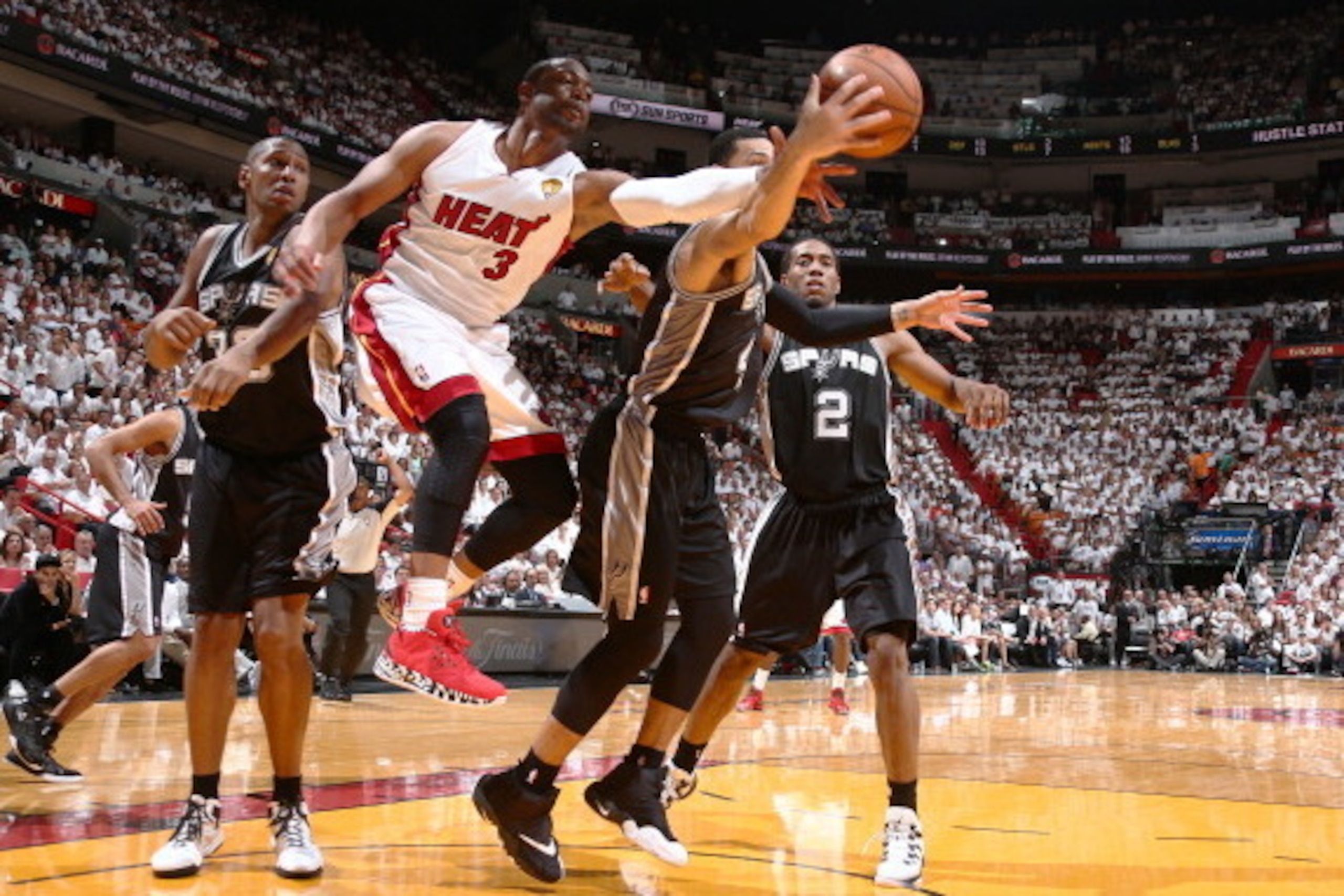 MIAMI, FL - JUNE 10: Dwyane Wade #3 of the Miami Heat defends Danny Green #4 of the San Antonio Spurs during Game Three of the 2014 NBA Finals at American Airlines Arena in Miami, Florida on June 10, 2014.  NOTE TO USER: User expressly acknowledges and ag