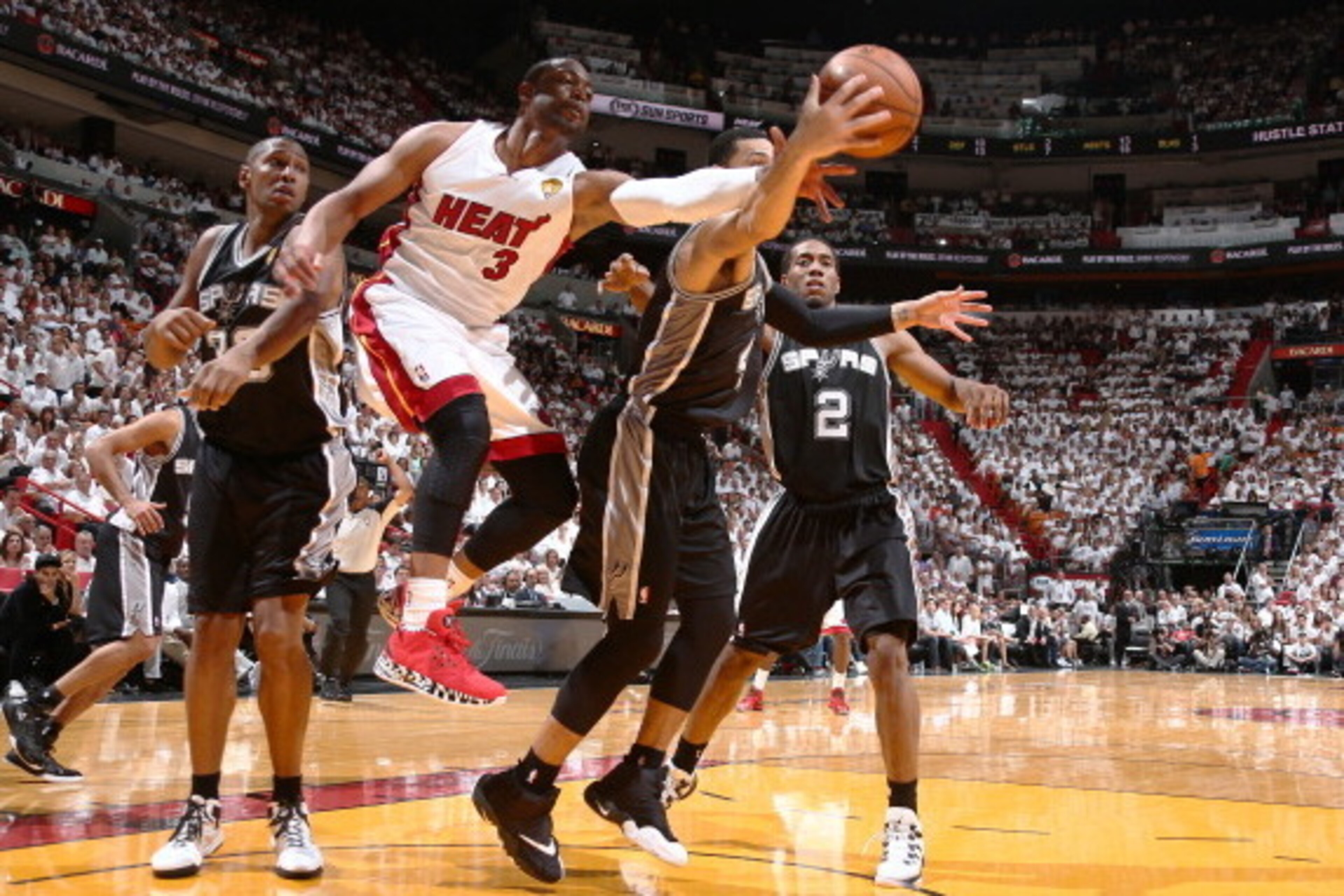 MIAMI, FL - JUNE 10: Dwyane Wade #3 of the Miami Heat defends Danny Green #4 of the San Antonio Spurs during Game Three of the 2014 NBA Finals at American Airlines Arena in Miami, Florida on June 10, 2014.  NOTE TO USER: User expressly acknowledges and ag