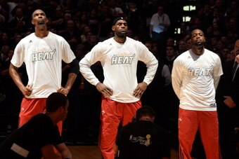 SAN ANTONIO, TX - JUNE 05: Chris Bosh #1, LeBron James #6 and Dwyane Wade #3 of the Miami Heat stand in observance of the national anthem before Game One of the 2014 NBA Finals between the Miami Heat and San Antonio Spurs at AT&T Center on June 5, 2014 in