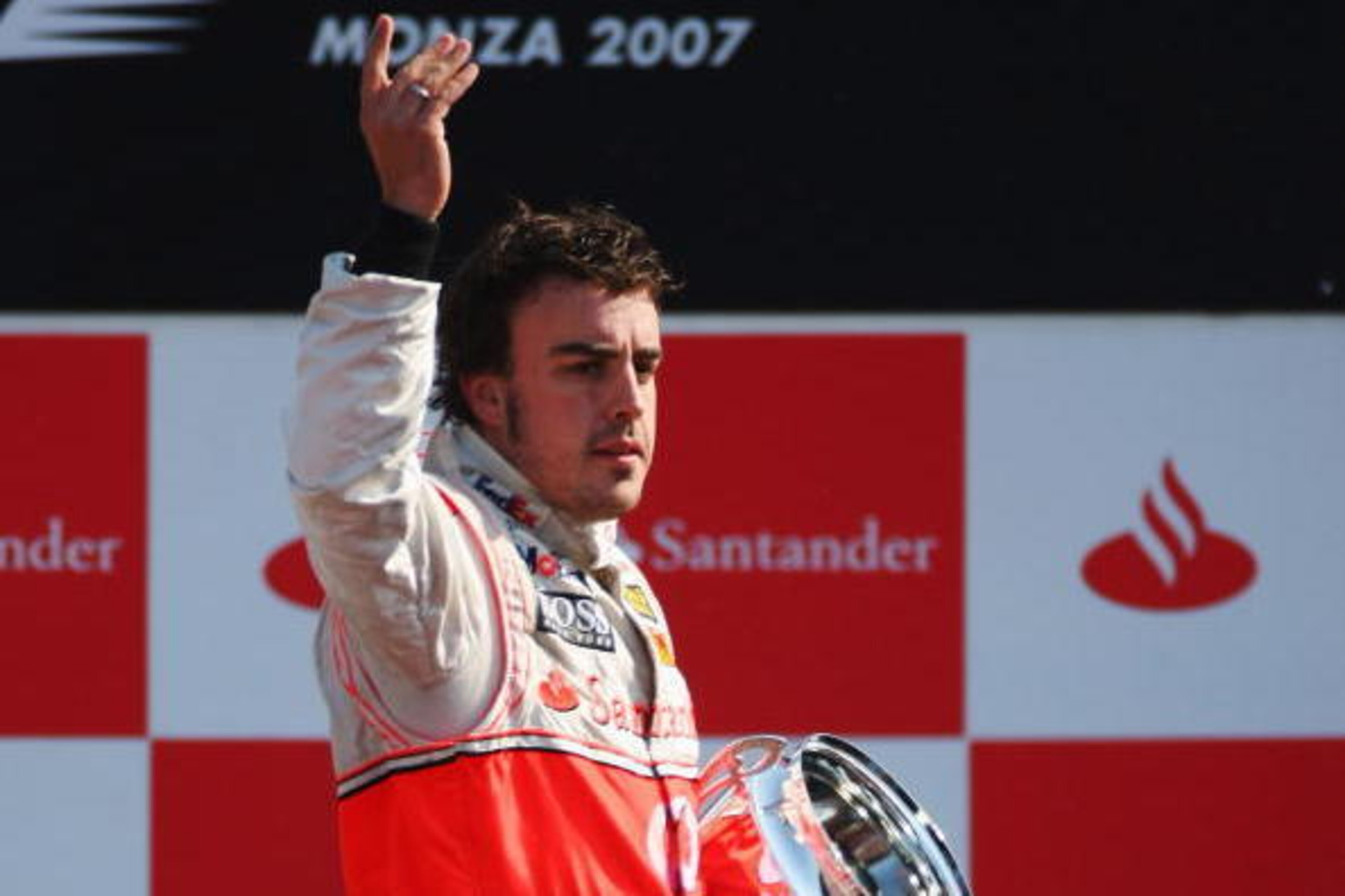 MONZA, ITALY - SEPTEMBER 09:  Fernando Alonso of Spain and McLaren celebrates on the podium after winning the Italian Formula One Grand Prix at the Autodromo Nazionale di Monza on September 9, 2007 in Monza, Italy.  (Photo by Clive Mason/Getty Images)