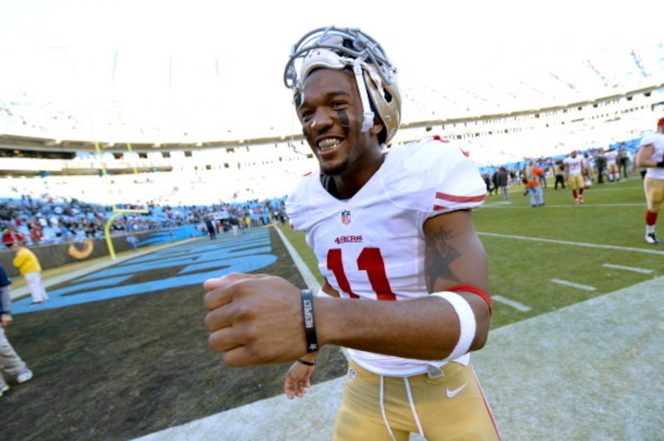 CHARLOTTE, NC - JANUARY 12: Quinton Patton #11 of the San Francisco 49ers runs off the field after defeating the Carolina Panthers during the NFC Divisional Playoff Game at Bank of America Stadium on January 12, 2014 in Charlotte, North Carolina. The 49er