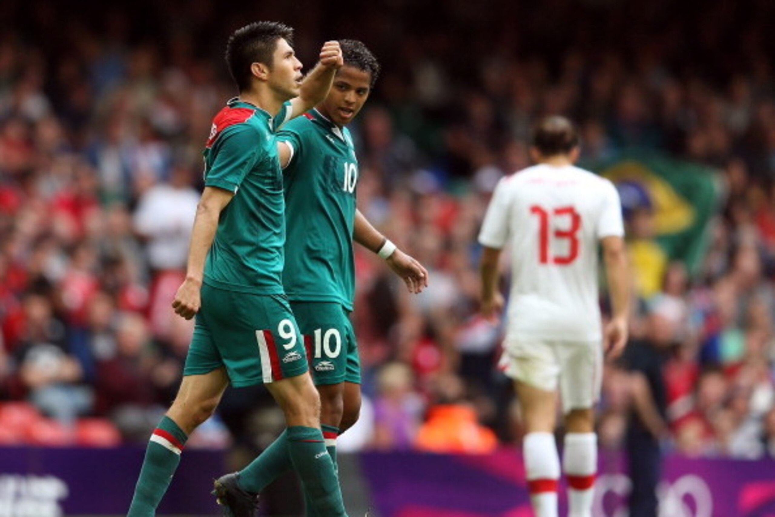 CARDIFF, WALES - AUGUST 01:  Oribe Peralta of Mexico celebrates scoring the first goal with Giovani dos Santos of Mexico during the Men's Football first round Group B match between Mexico and Switzerland on Day 5 of the London 2012 Olympic Games at Millen