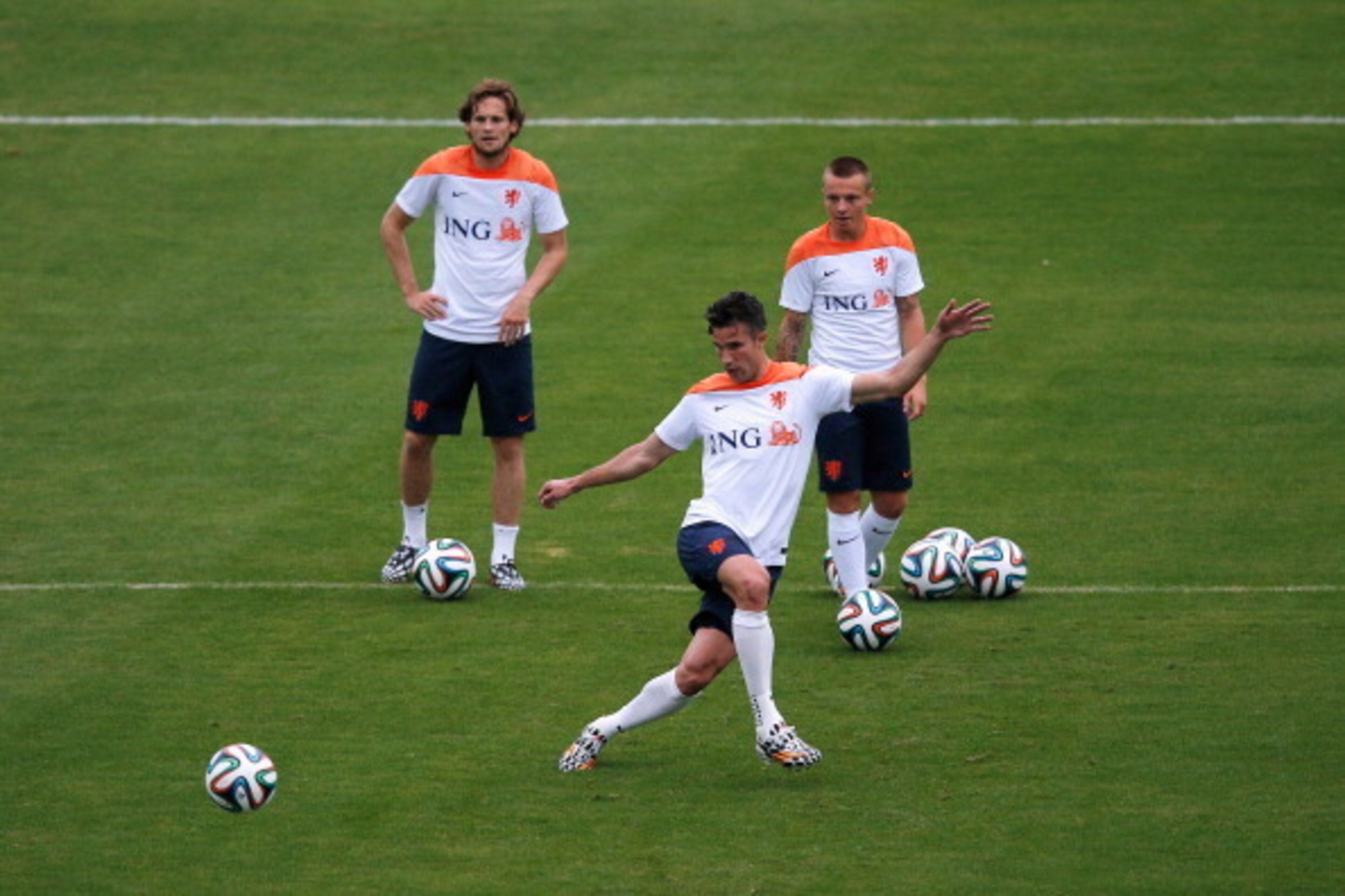 RIO DE JANEIRO, BRAZIL - JUNE 10:  Jordy Clasie, Robin van Persie (kicking the ball) and Daley Blind in action during the Netherlands training session at the 2014 FIFA World Cup Brazil held at the Estadio Jose Bastos Padilha Gavea on June 10, 2014 in Rio 