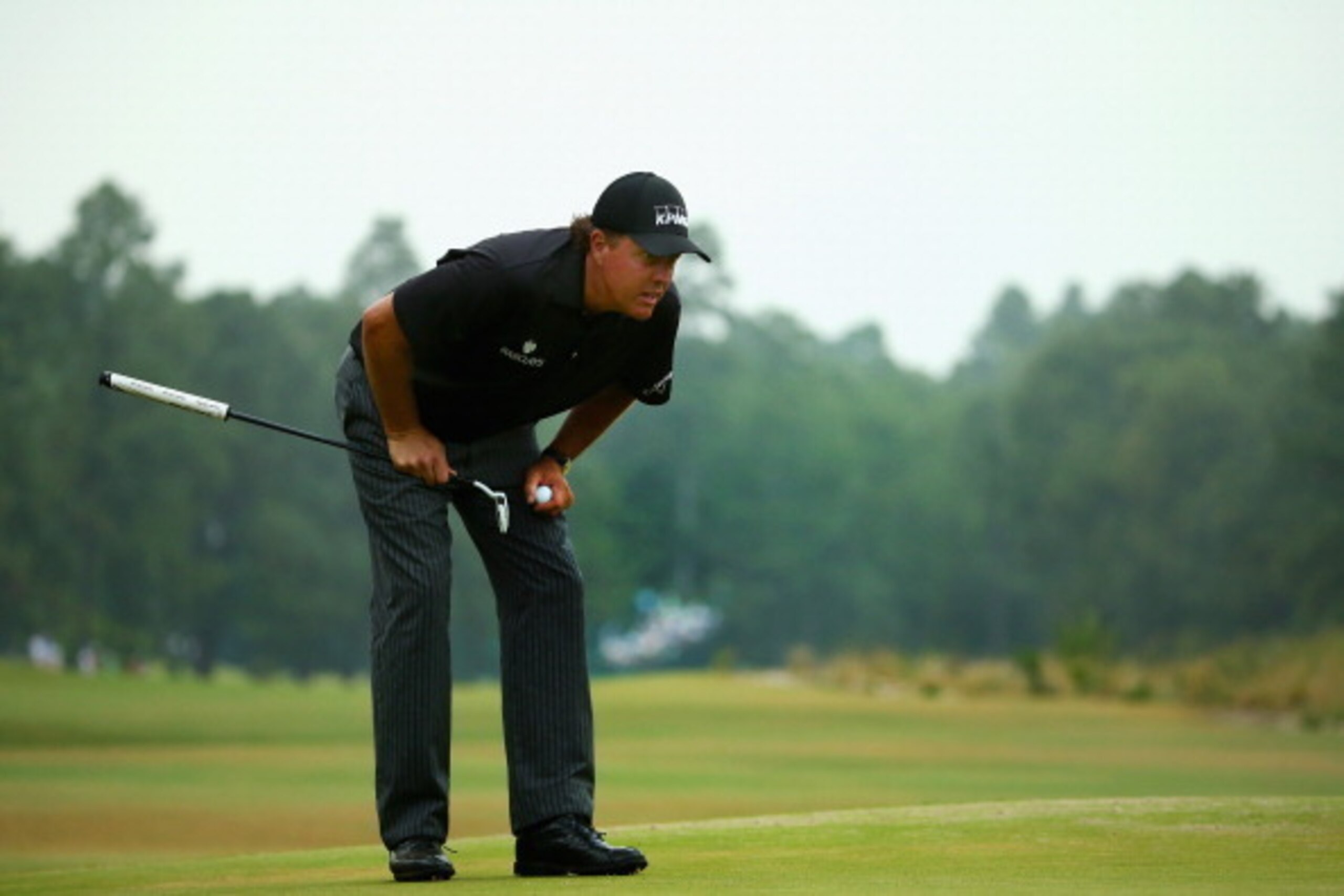 PINEHURST, NC - JUNE 12: Phil Mickelson of the United States evaluates the tenth green during the first round of the 114th U.S. Open at Pinehurst Resort & Country Club, Course No. 2 on June 12, 2014 in Pinehurst, North Carolina.  (Photo by Streeter Lecka/
