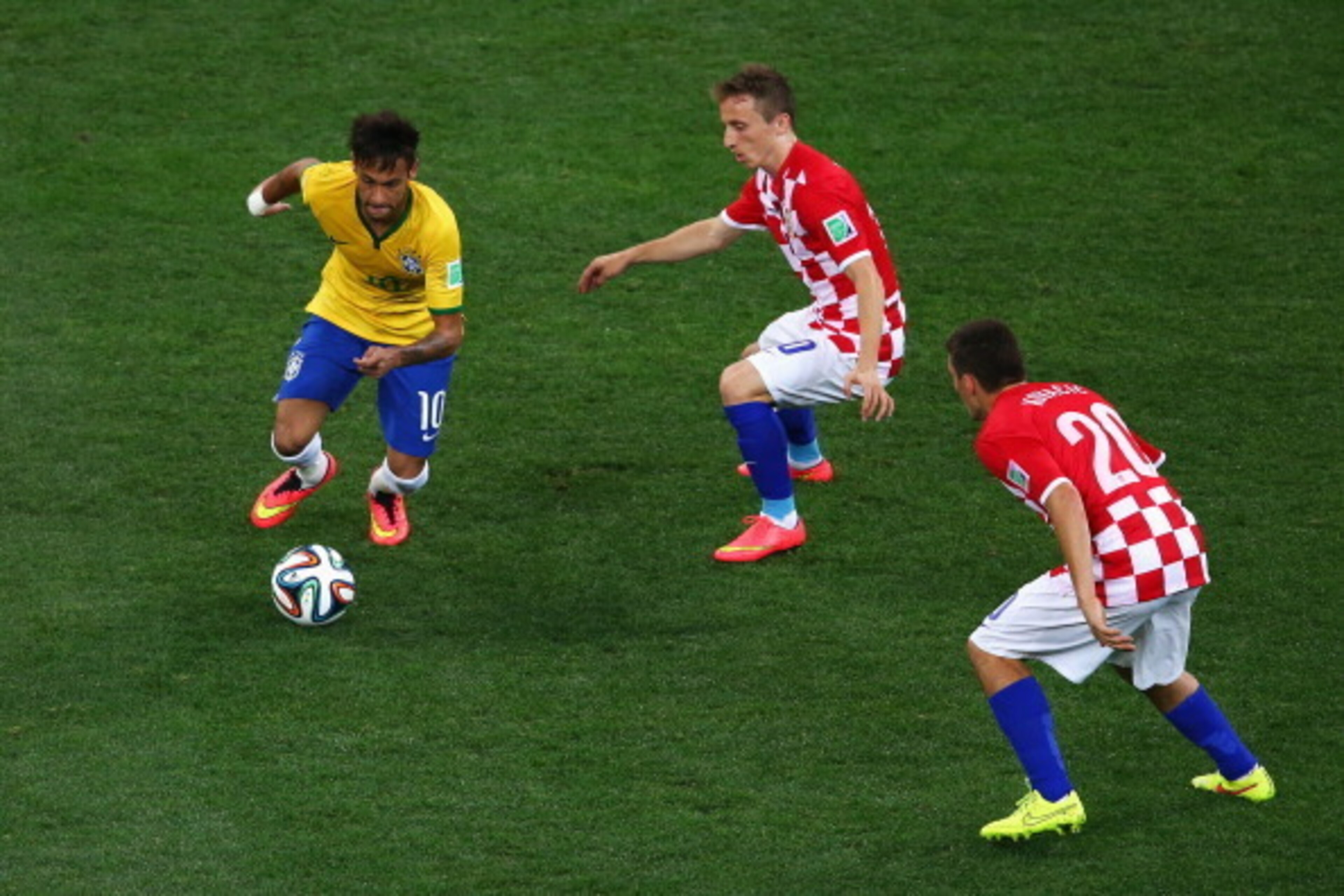 SAO PAULO, BRAZIL - JUNE 12:  Neymar of Brazil controls the ball as Luka Modric and Mateo Kovacic (R) of Croatia  and during the 2014 FIFA World Cup Brazil Group A match between Brazil and Croatia at Arena de Sao Paulo on June 12, 2014 in Sao Paulo, Brazi