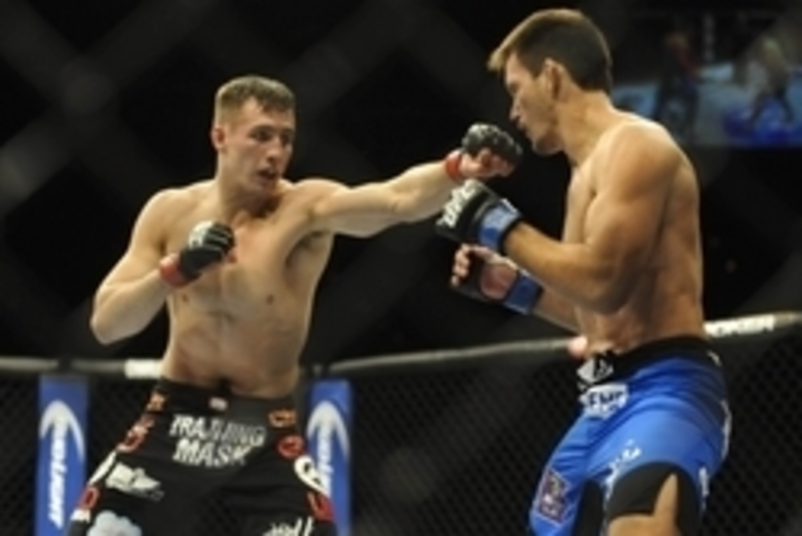 Feb 22, 2014; Las Vegas, NV, USA;  Rory MacDonald (red gloves) throws a punch at Demian Maia (blue gloves) during their UFC welterweight bout at Mandalay Bay. MacDonald won by way of a 29-28 decision. Mandatory Credit: Stephen R. Sylvanie-USA TODAY Sports