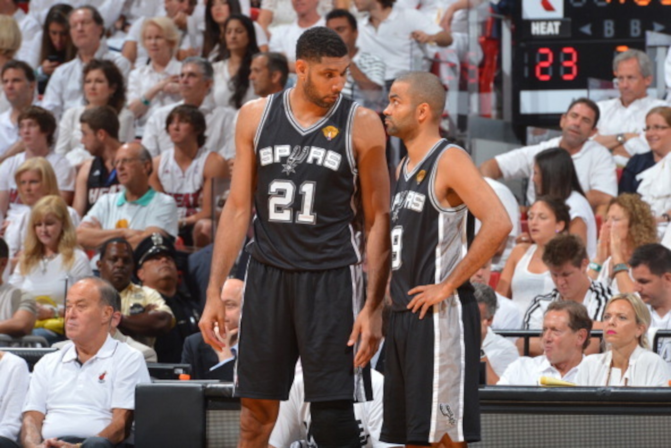 MIAMI, FL - JUNE 12: Tim Duncan #21 and Tony Parker #9 of the San Antonio Spurs share a moment on the sidelines against the Miami Heat during Game Six of the 2014 NBA Finals on June 12, 2014 at American Airlines Arena in Miami, Florida. NOTE TO USER: User