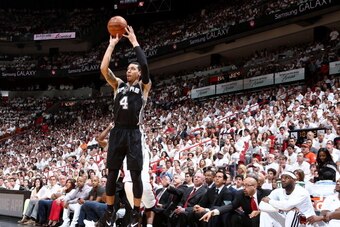 MIAMI, FL - JUNE 12: Miami Heat players watch as Danny Green #4 of the San Antonio Spurs shoots a three pointer during Game Four of the 2014 NBA Finals at American Airlines Arena in Miami, Florida on June 12, 2014.  NOTE TO USER: User expressly acknowledg