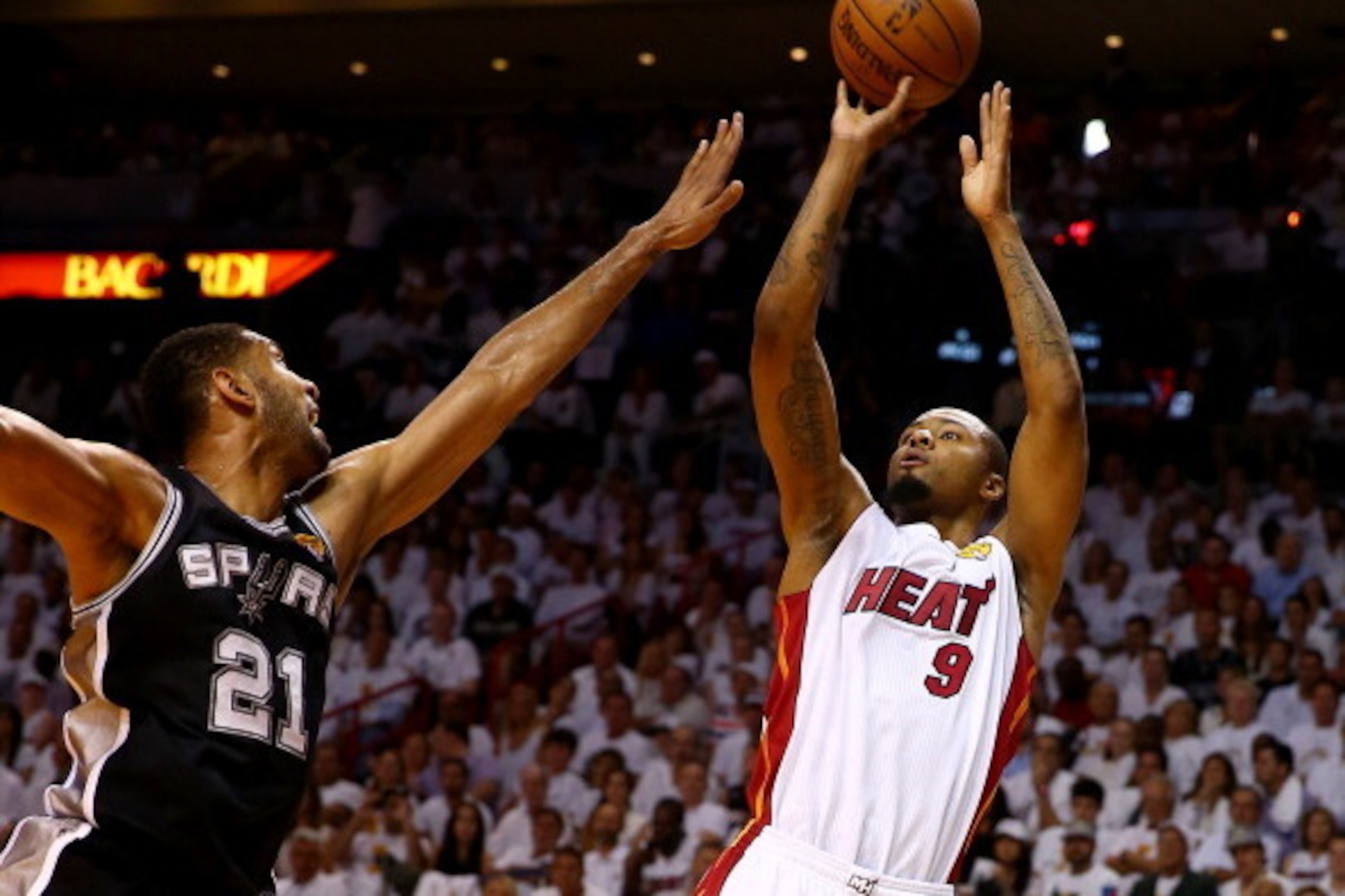 MIAMI, FL - JUNE 12:  Rashard Lewis #9 of the Miami Heat takes a shot over Tim Duncan #21 of the San Antonio Spurs during Game Four of the 2014 NBA Finals at American Airlines Arena on June 12, 2014 in Miami, Florida. NOTE TO USER: User expressly acknowle