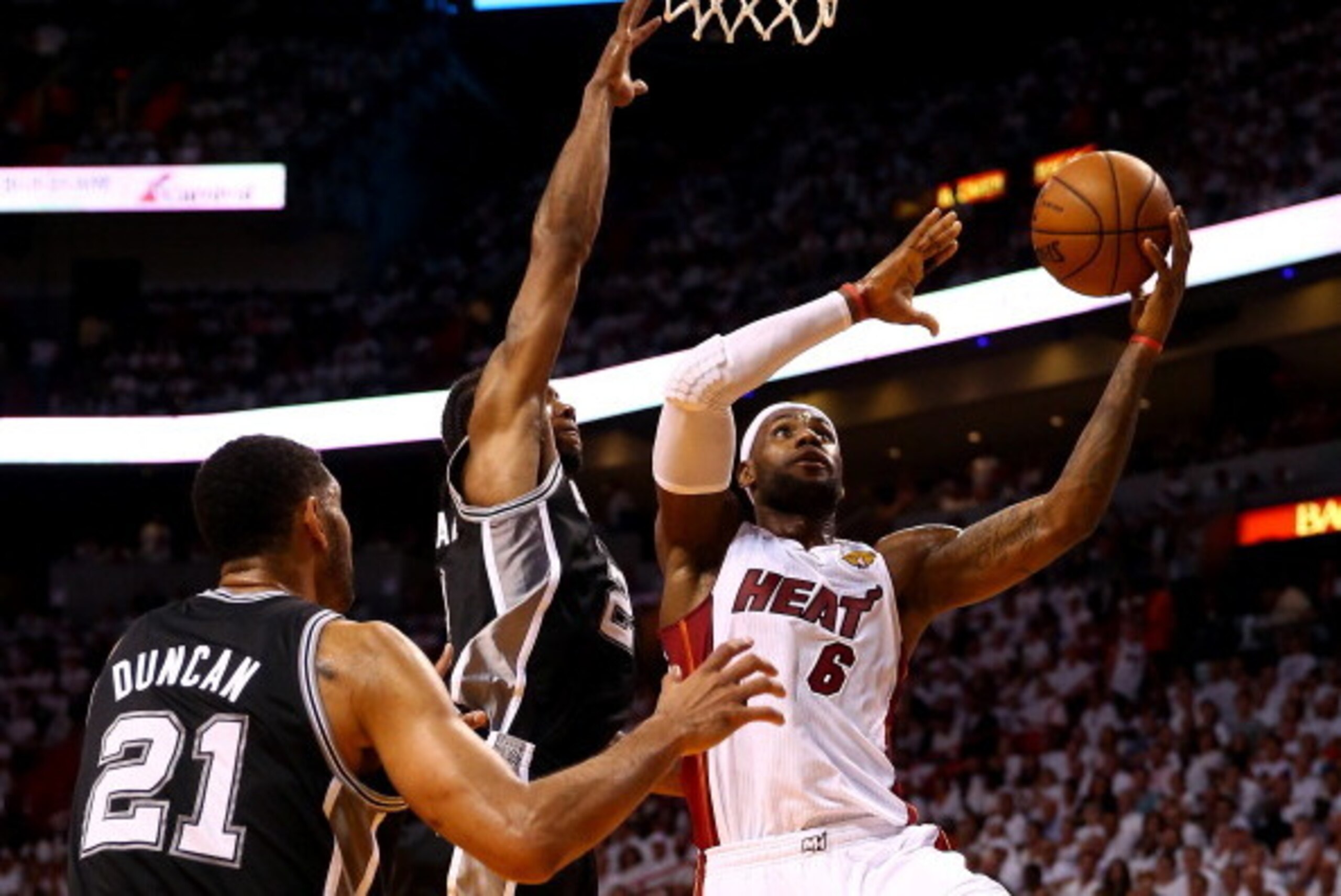 MIAMI, FL - JUNE 12:  LeBron James #6 of the Miami Heat goes to the basket against Kawhi Leonard #2 and Tim Duncan #21 of the San Antonio Spurs during Game Four of the 2014 NBA Finals at American Airlines Arena on June 12, 2014 in Miami, Florida. NOTE TO 