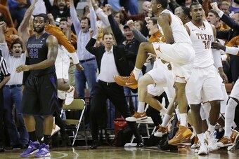Texas players celebrate as Gipson looks on in disbelief following Jonathan Holmes' buzzer-beater against K-State.