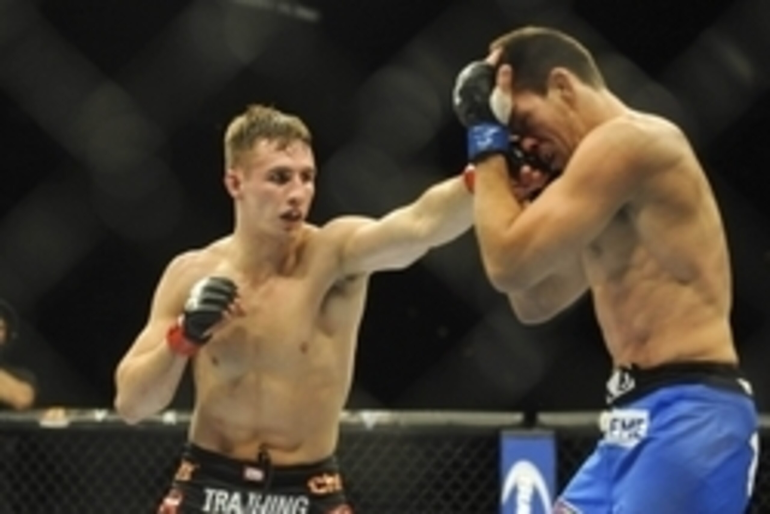 Feb 22, 2014; Las Vegas, NV, USA; Rory MacDonald (red gloves) lands a punch on Demian Maia (blue gloves) during their UFC welterweight bout at Mandalay Bay. MacDonald won by way of a 29-28 decision. Mandatory Credit: Stephen R. Sylvanie-USA TODAY Sports Feb 22, 2014; Las Vegas, NV, USA; Rory MacDonald (red gloves) lands a punch on Demian Maia (blue gloves) during their UFC welterweight bout at Mandalay Bay. MacDonald won by way of a 29-28 decision. Mandatory Credit: Stephen R. Sylvanie-USA TODAY Sports