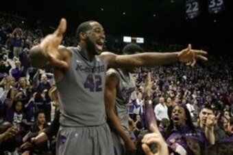 Feb 10, 2014; Manhattan, KS, USA; Kansas State Wildcats forward Thomas Gipson (42) celebrates an 85-82 overtime win over the Kansas Jayhawks at Fred Bramlage Coliseum. Mandatory Credit: Scott Sewell-USA TODAY Sports