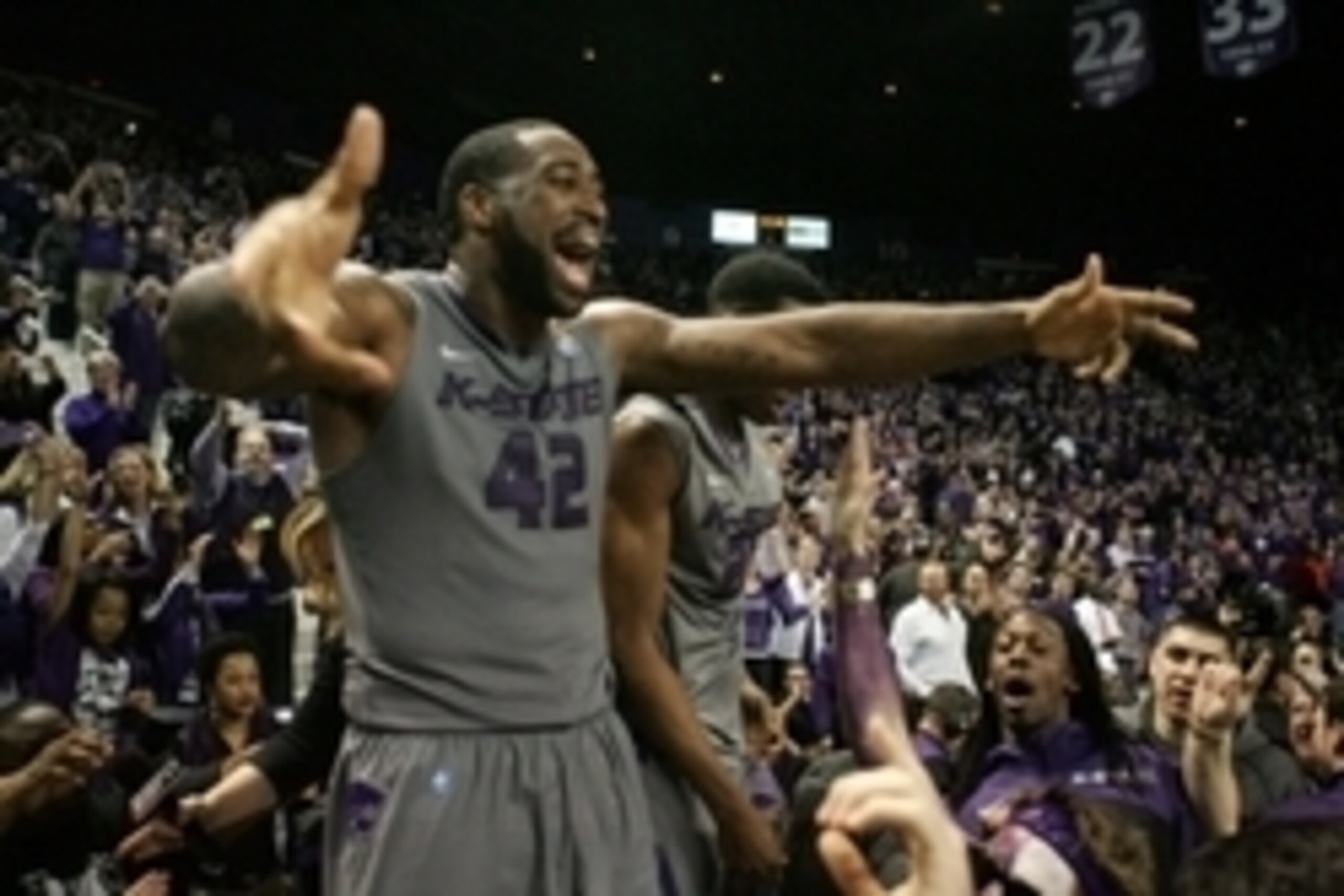 Feb 10, 2014; Manhattan, KS, USA; Kansas State Wildcats forward Thomas Gipson (42) celebrates an 85-82 overtime win over the Kansas Jayhawks at Fred Bramlage Coliseum. Mandatory Credit: Scott Sewell-USA TODAY Sports