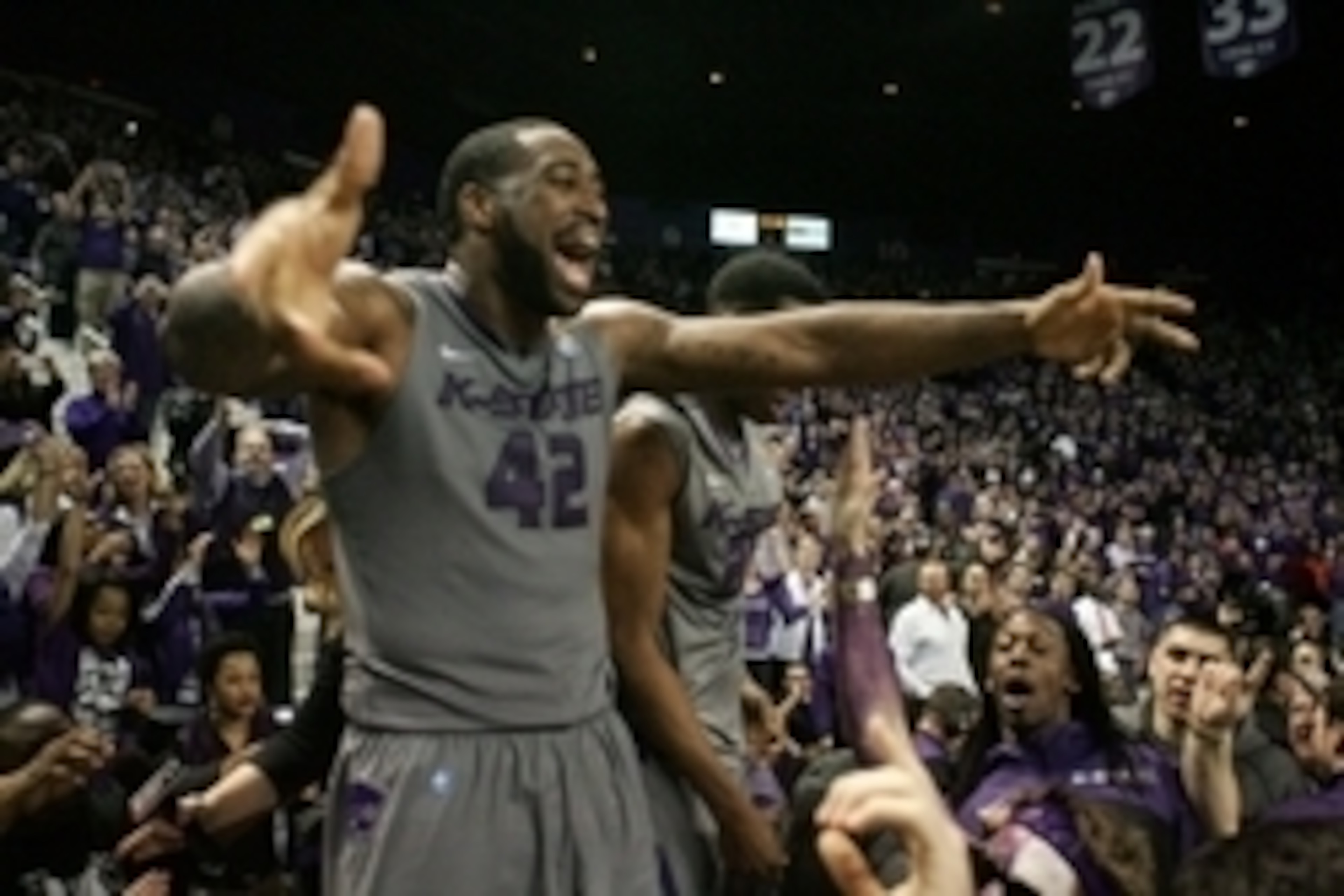 Feb 10, 2014; Manhattan, KS, USA; Kansas State Wildcats forward Thomas Gipson (42) celebrates an 85-82 overtime win over the Kansas Jayhawks at Fred Bramlage Coliseum. Mandatory Credit: Scott Sewell-USA TODAY Sports