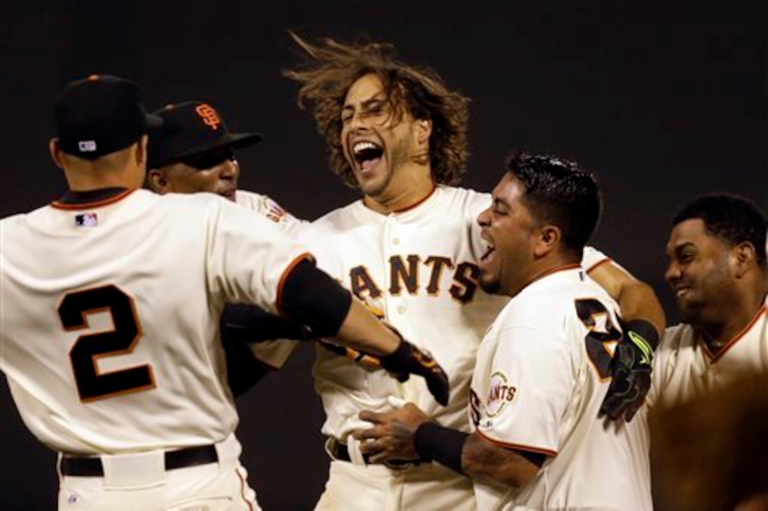 Michael Morse, (center), celebrates his walk-off hit against the Mets to give the Giants a victory.