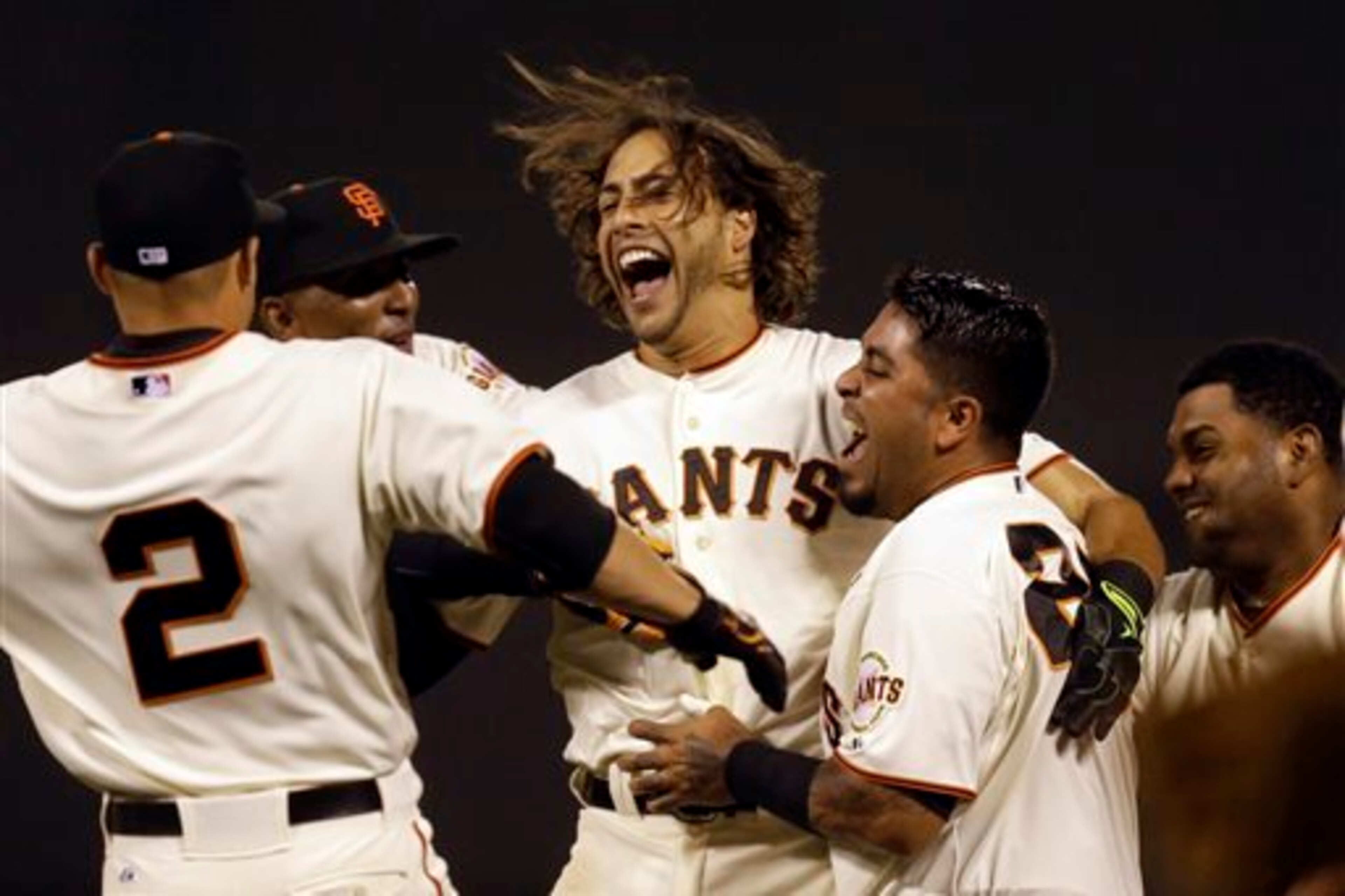 Michael Morse, (center), celebrates his walk-off hit against the Mets to give the Giants a victory.