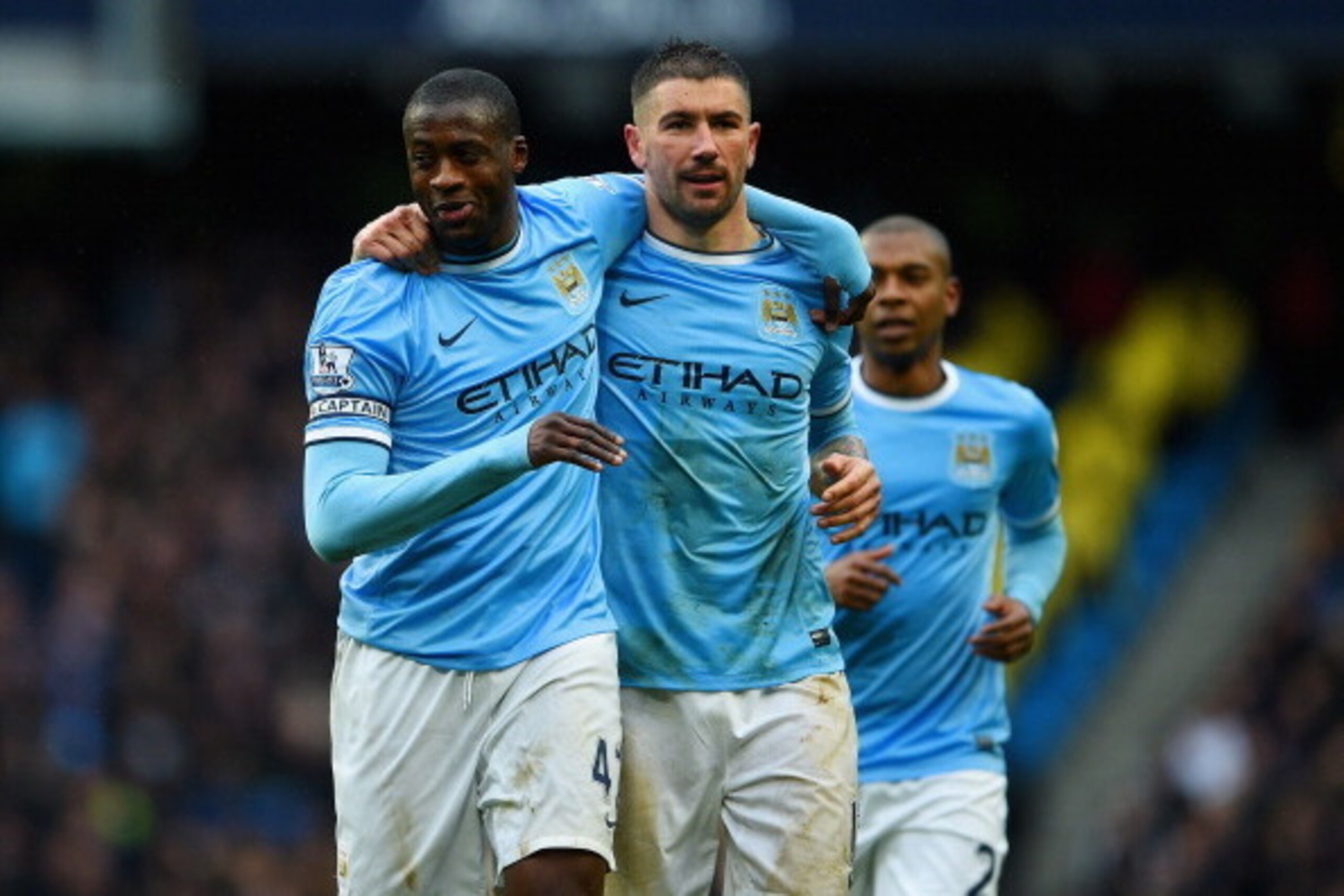 MANCHESTER, ENGLAND - MARCH 22:  Yaya Toure of Manchester City celebrates scoring his hat trick with Aleksandar Kolarov of Manchester City during the Barclays Premier League match between Manchester City and Fulham at Etihad Stadium on March 22, 2014 in M