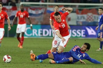 ST GALLEN, SWITZERLAND - MARCH 05: Mate Males of Croatia (R) challenges Josip Drmic of Switzerland (L) during the international friendly match between Switzerland and Croatia at the AFG Arena on March 5, 2014 in St Gallen, Switzerland.  (Photo by Marc Eic