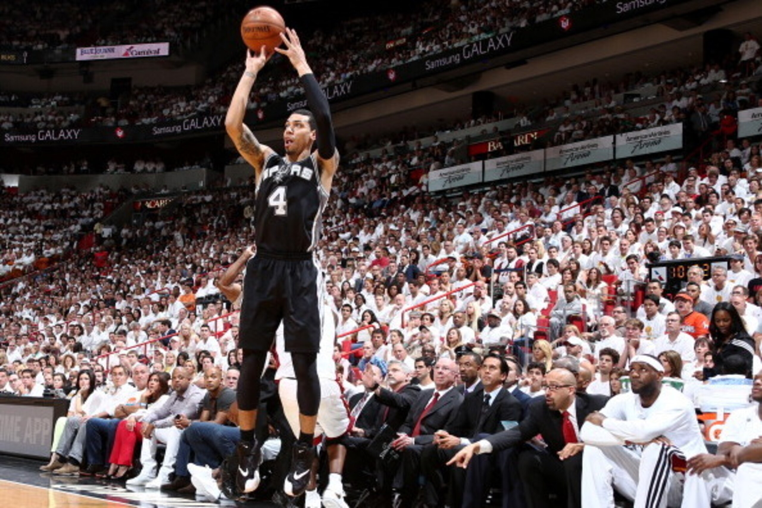 MIAMI, FL - JUNE 12: Miami Heat players watch as Danny Green #4 of the San Antonio Spurs shoots a three pointer during Game Four of the 2014 NBA Finals at American Airlines Arena in Miami, Florida on June 12, 2014.  NOTE TO USER: User expressly acknowledg