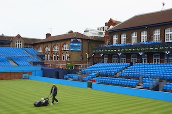 LONDON, ENGLAND - JUNE 05:  The groundsman cuts the grass on centre court as the new layout turns from red to blue at Queens Club on June 5, 2009 in London, England. The newly named AEGON Championships will run from 8th June to 14th June 2009.  (Photo by 