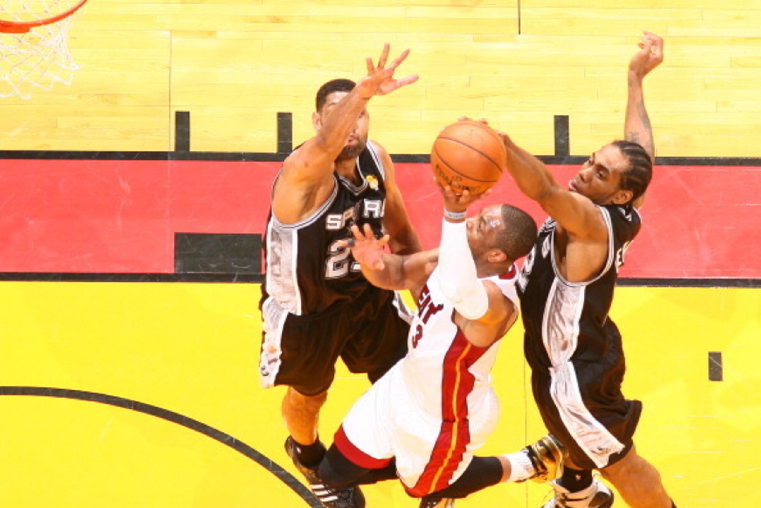 MIAMI, FL - JUNE 12: Dwyane Wade #3 of the Miami Heat blocked by Tim Duncan #21 of the San Antonio Spurs and Kawhi Leonard during Game Four of the 2014 NBA Finals at American Airlines Arena in Miami, Florida on June 12, 2014.  NOTE TO USER: User expressly