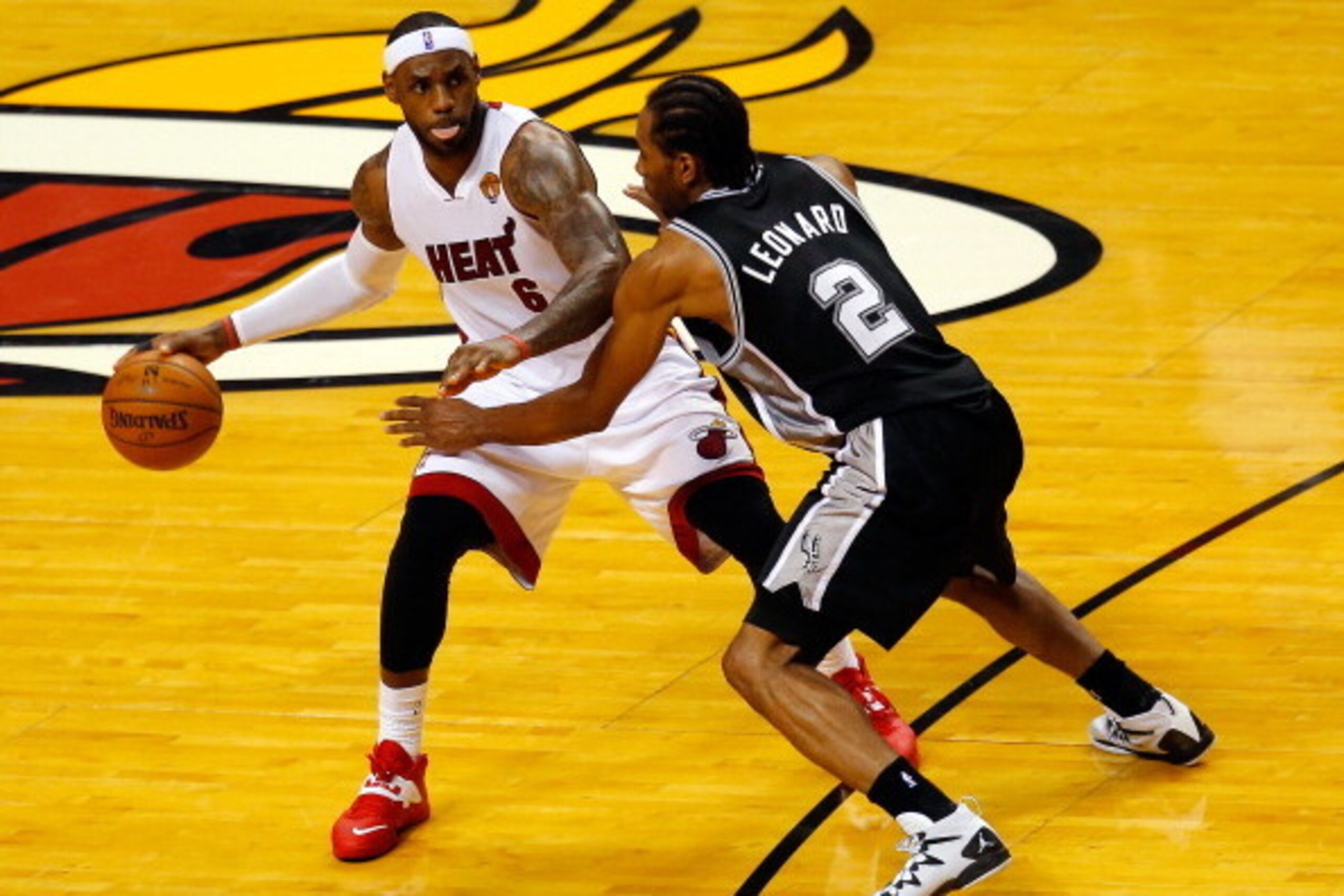 MIAMI, FL - JUNE 12:  LeBron James #6 of the Miami Heat controls the ball as Kawhi Leonard #2 of the San Antonio Spurs defends during Game Four of the 2014 NBA Finals at American Airlines Arena on June 12, 2014 in Miami, Florida. NOTE TO USER: User expres